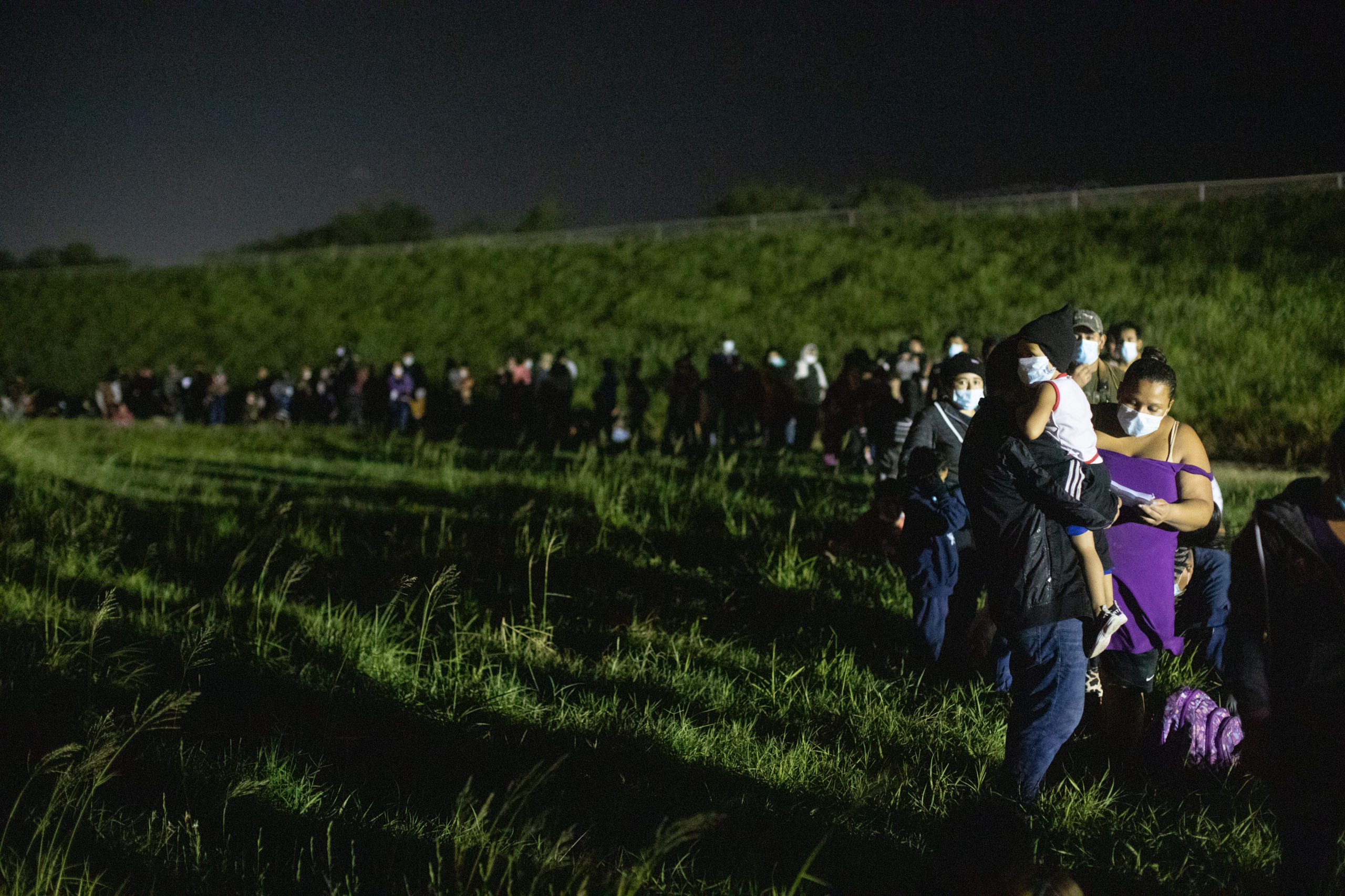 Hundreds of migrants waited in a line to be processed by four Customs and Border Protection agents ​near the Hidalgo Point of Entry on August 9, 2021. (Kaylee Greenlee - Daily Caller News Foundation