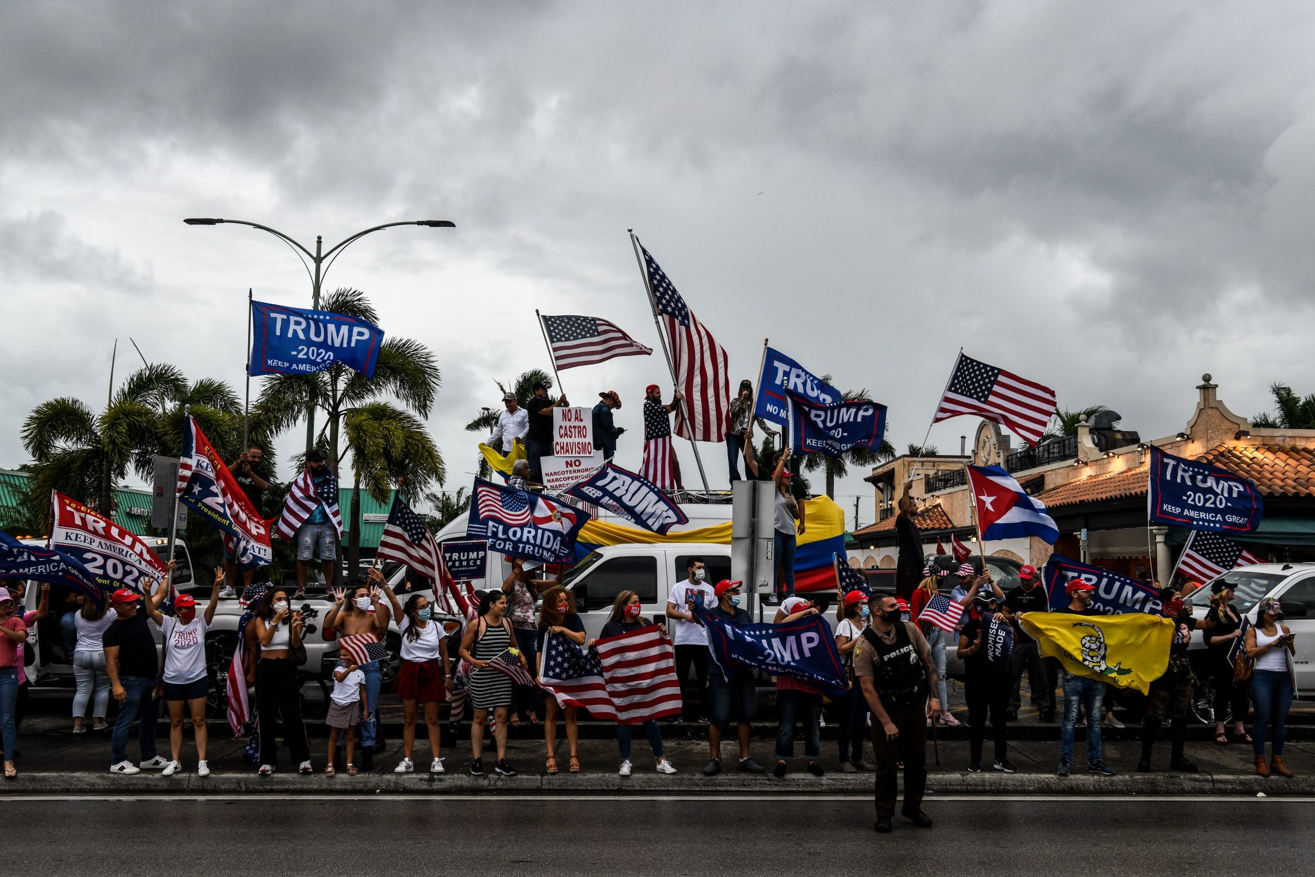 Supporters of US President Donald Trump hold signs and flags during a protest in Miami on November 7, 2020, after Joe Biden was declared the winner of the 2020 presidential election. - Democrat Joe Biden has won the White House, US media said November 7, defeating Donald Trump and ending a presidency that convulsed American politics, shocked the world and left the United States more divided than at any time in decades. (Photo by CHANDAN KHANNA / AFP) (Photo by CHANDAN KHANNA/AFP via Getty Images)