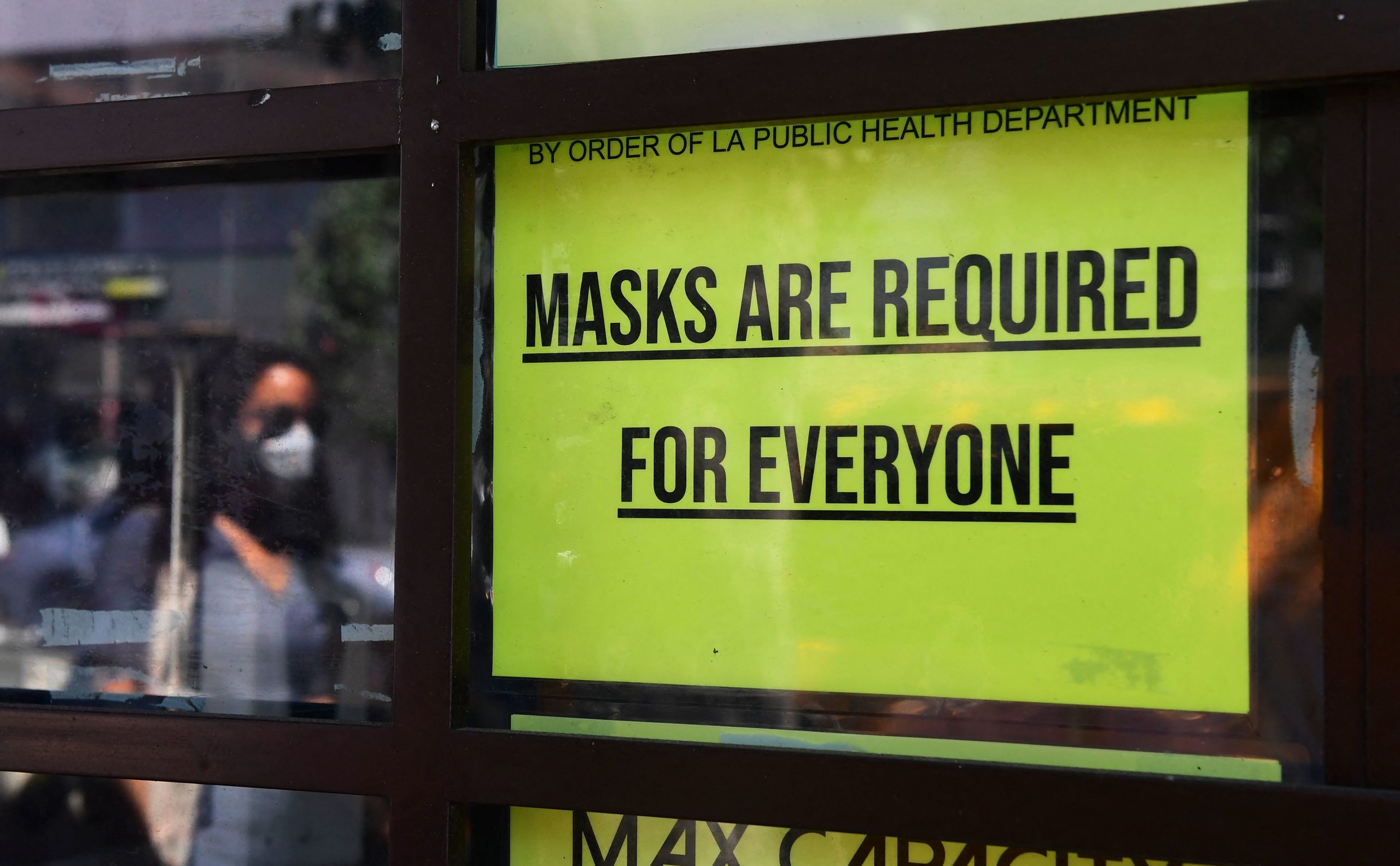 A storefront sign reminds people masks are for everyone on July 19, 2021 in Los Angeles, California. - A continuing resurgence in the Covid-19 pandemic is seeing local rates rise and hospitalizations skyrocket amid a new face-covering mandate that went into effect over the weekend. (Photo by Frederic J. BROWN / AFP) (Photo by FREDERIC J. BROWN/AFP via Getty Images)