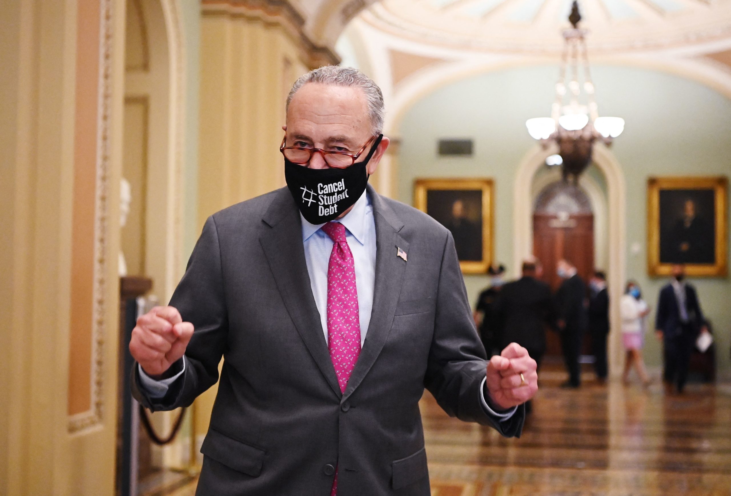 Majority Leader Chuck Schumer exits the Senate chamber after the Senate passed the infrastructure bill with 69 votes. (MANDEL NGAN/AFP via Getty Images)