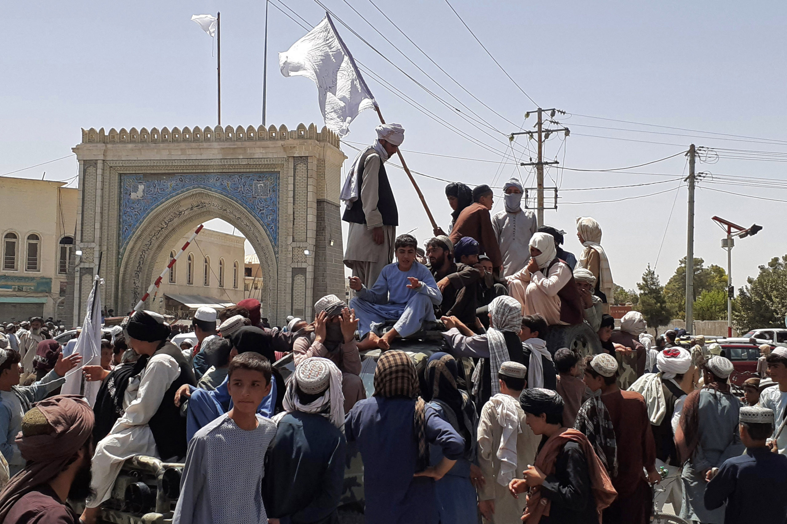 Taliban fighters stand on a vehicle along the roadside in Kandahar on Friday. (AFP via Getty Images)