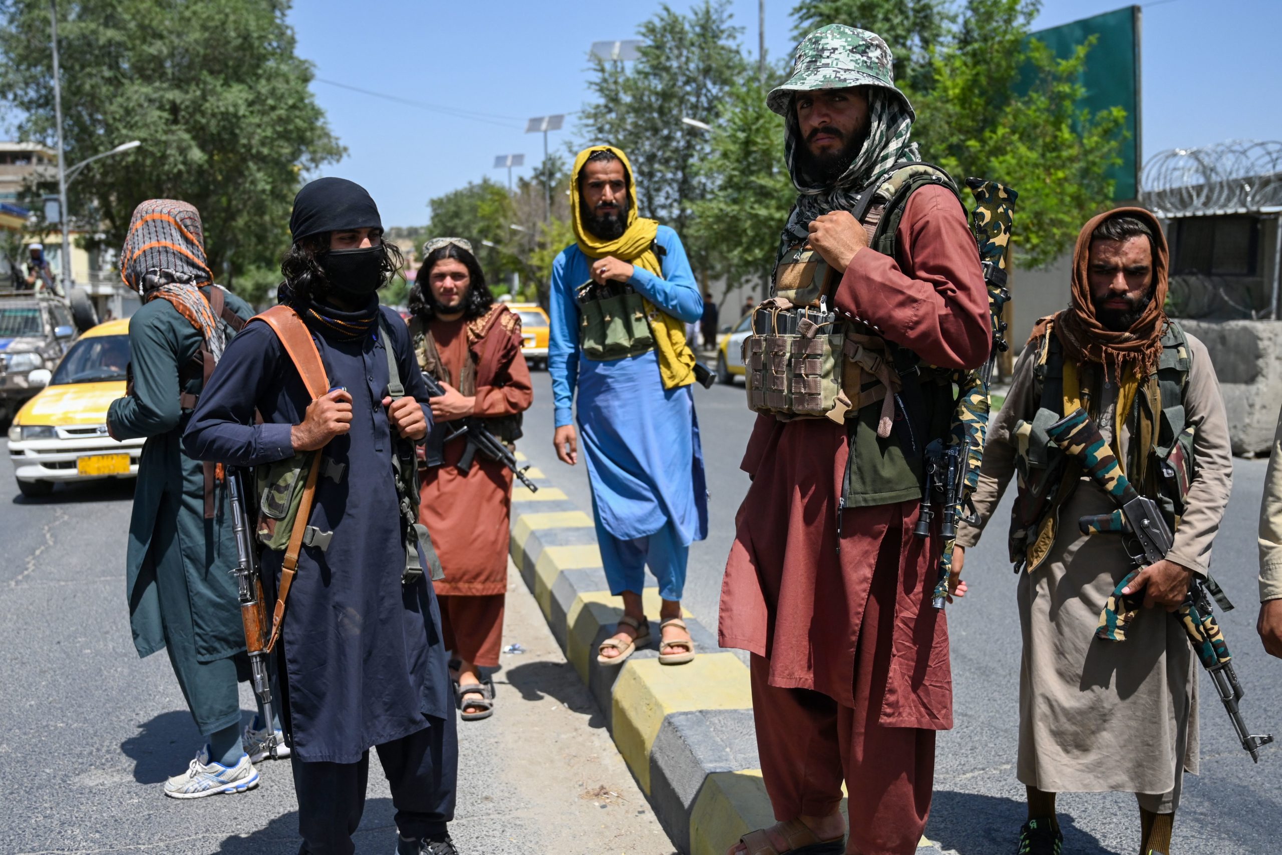Taliban fighters stand guard along a street in Kabul on Aug. 16. (WAKIL KOHSAR/AFP via Getty Images)