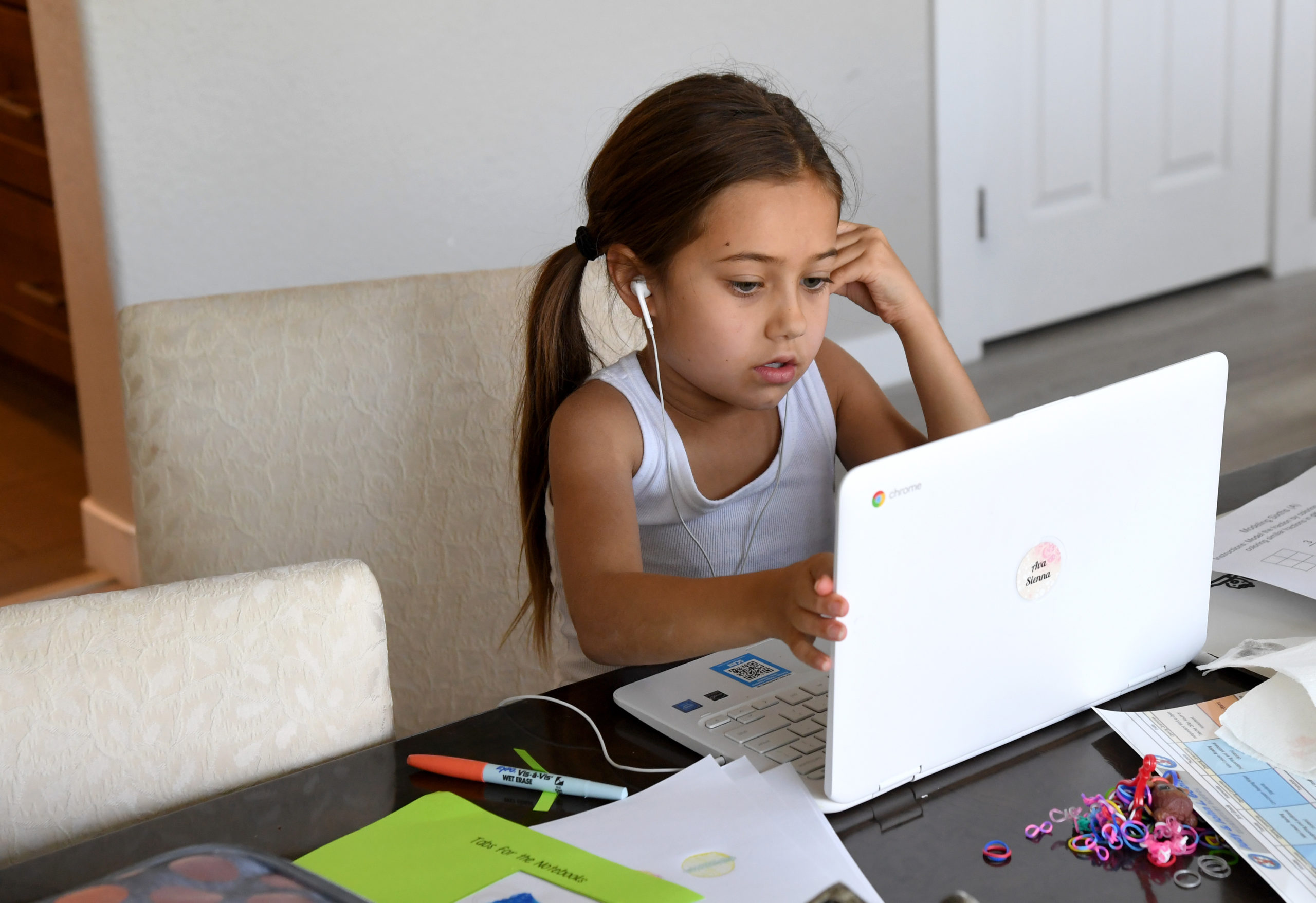 LAS VEGAS, NEVADA - AUGUST 25: Goolsby Elementary School third grader Ava Dweck, 9, takes an online class at a friend's home during the first week of distance learning for the Clark County School District amid the spread of the coronavirus (COVID-19) on August 25, 2020 in Las Vegas, Nevada. CCSD, the fifth-largest school district in the United States with more than 315,000 students, decided to start the school year with a full-time distance education instructional model as part of its Reopening Our Schools Plan due to health and safety concerns over the pandemic. (Photo by Ethan Miller/Getty Images)
