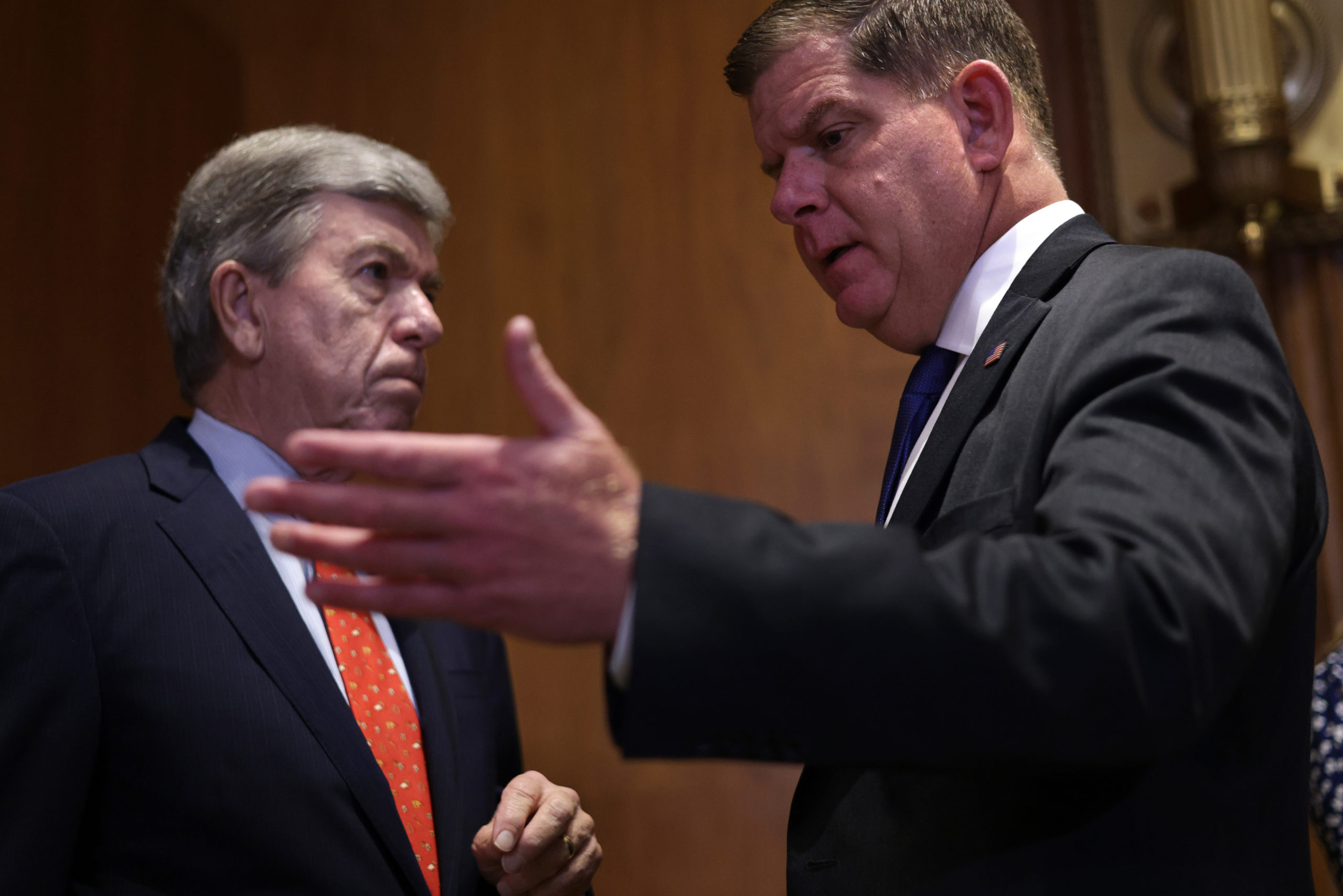 Secretary of Labor Marty Walsh talks to Republican Sen. Roy Blunt following a hearing on July 14. (Alex Wong/Getty Images)