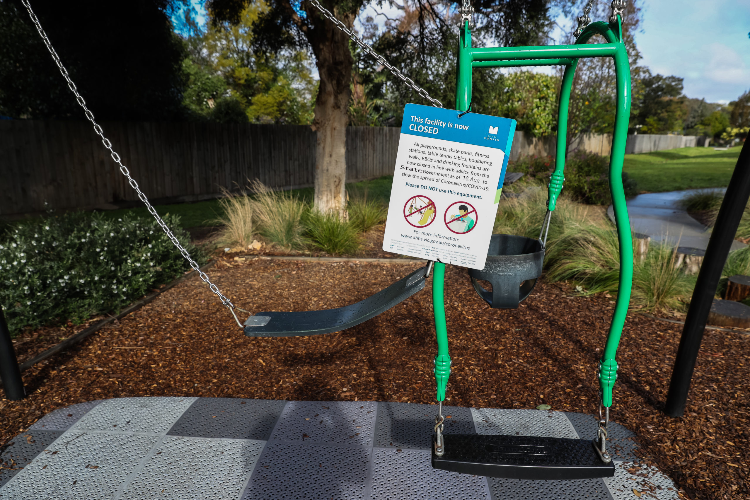 Two swings are seen tied together with a sign advising the closure of a playground in the city of Monash on August 17, 2021 in Melbourne, Australia. (Photo by Asanka Ratnayake/Getty Images)