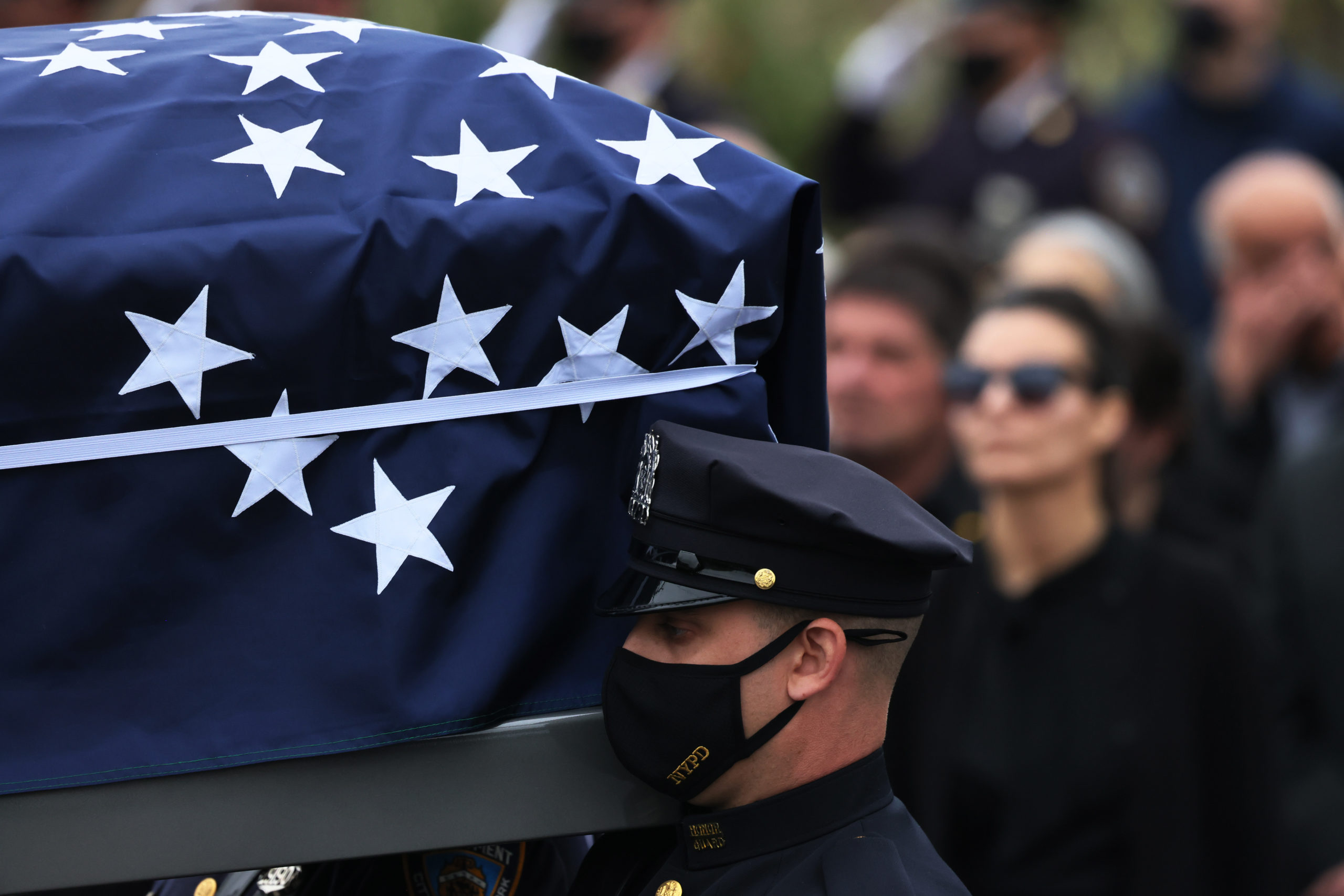 Pallbearers carry the casket of NYPD Officer Anastasios Tsakos towards a hearse during his funeral service at St. Paraskevi Greek Orthodox Shrine Church on May 04, 2021 in Greenlawn, New York. (Photo by Michael M. Santiago/Getty Images)