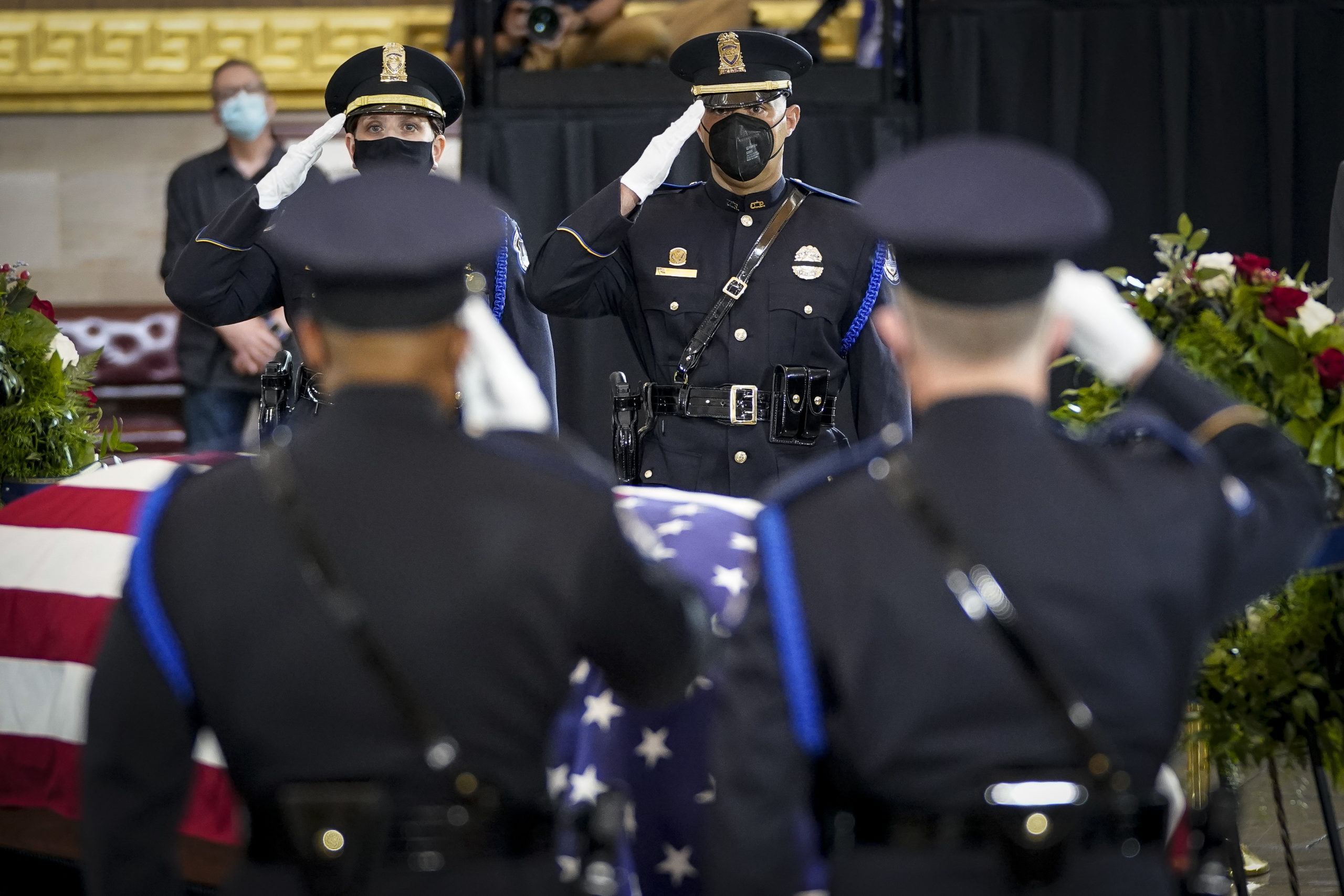 Members of a Capitol Police honor guard salute at the casket of the late U.S. Capitol Police officer William "Billy" Evans during a memorial service. (Photo by Drew Angerer/Getty Images)