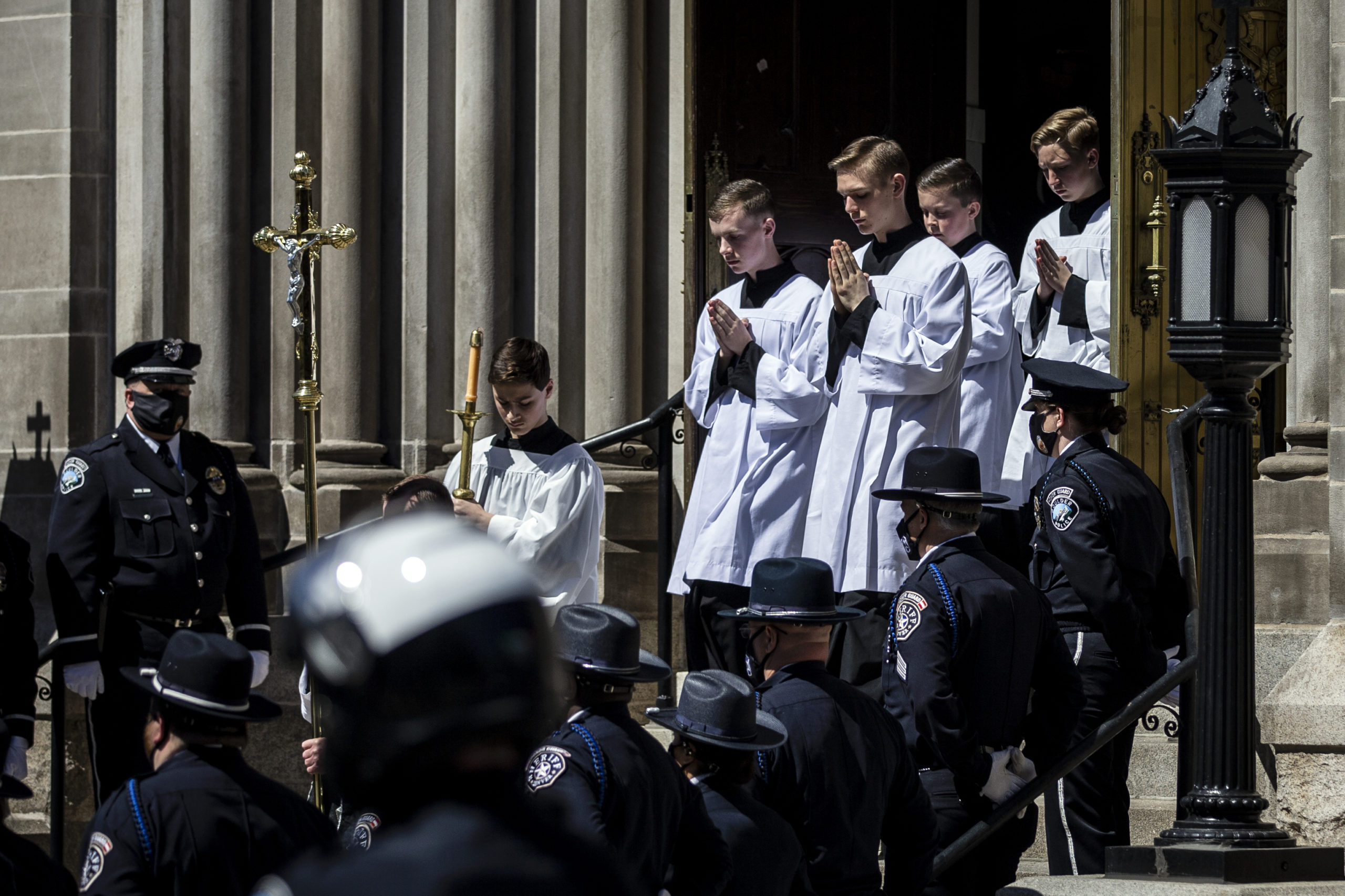 A procession makes its way out of The Cathedral Basilica of the Immaculate Conception during a Funeral Mass for slain Boulder Police officer Eric Talley on March 29, 2021 in Denver, Colorado. (Photo by Chet Strange/Getty Images)