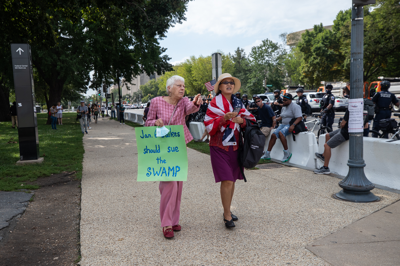 A woman attended the "Justice for J6" rally in Washington, D.C. holding a "Jan. 6 jailees should sue the swamp" on September 18, 2021. She told the DCNF that she considered writing "the pants off of Nancy Pelosi" in place of "swamp." ​(Kaylee Greenlee - Daily Caller News Foundation)