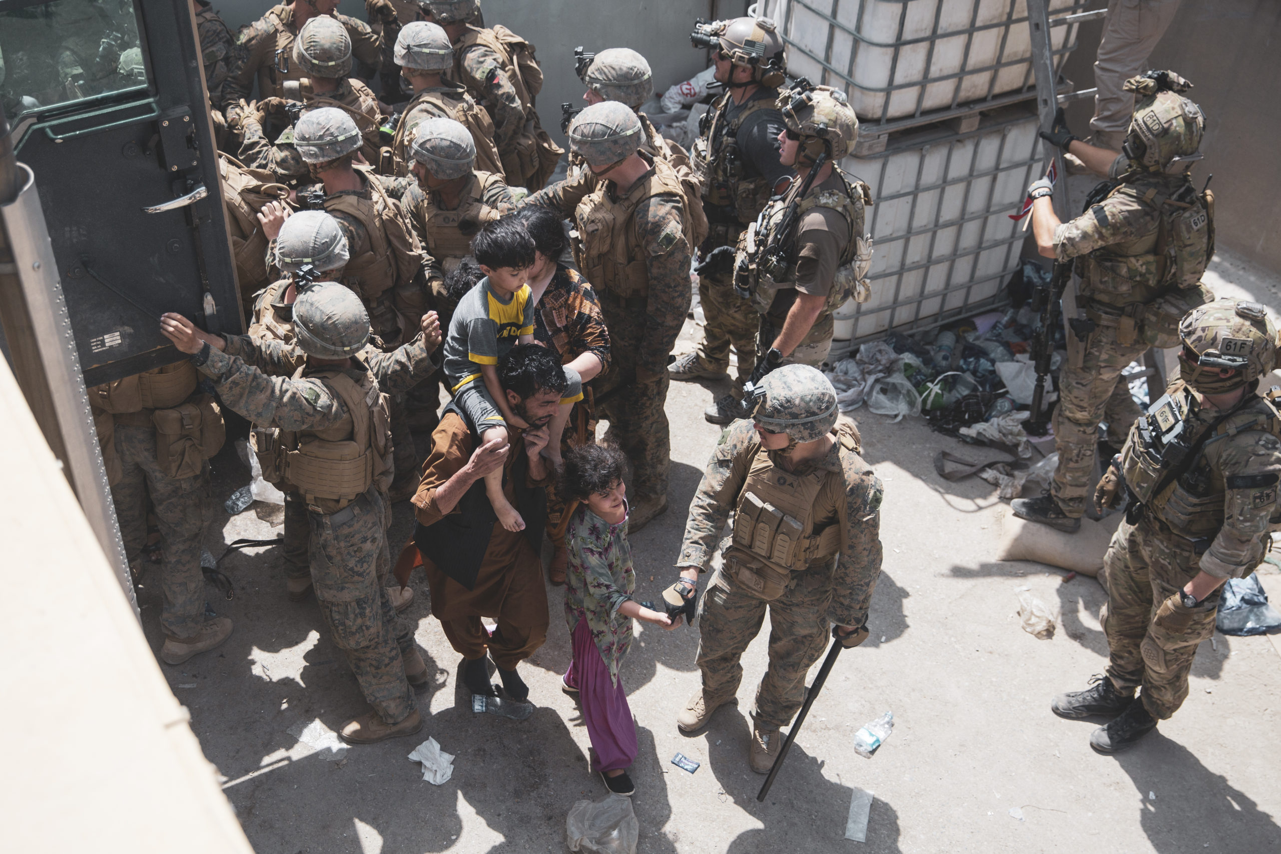 U.S. Marines assist with security at an evacuation checkpoint ensuring evacuees are processed safely at Hamid Karzai International Airport on Aug. 20. (Staff Sgt. Victor Mancilla/U.S. Marine Corps via Getty Images)