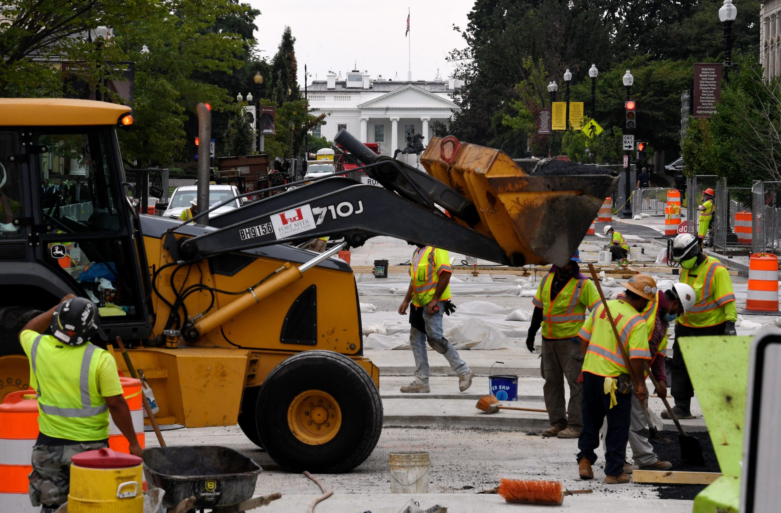 Construction workers repair a street near the White House on Tuesday. (Olivier Douliery/AFP via Getty Images)