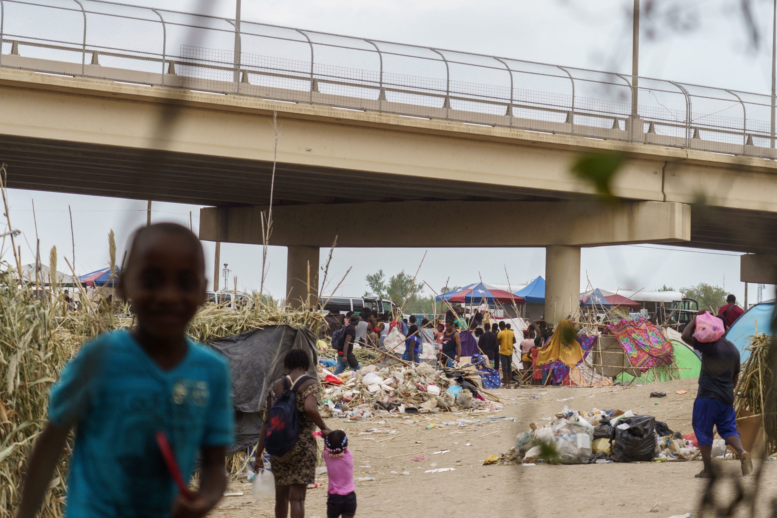 Haitian migrants are pictured in a makeshift encampment where more than 12,000 people hoping to enter the United States await under the international bridge in Del Rio, Texas on September 21, 2021. - The United Nations expressed deep concern September 21, 2021, at mass deportations of Haitian migrants from the United States, warning they could go against international law. (Photo by PAUL RATJE / AFP) (Photo by PAUL RATJE/AFP via Getty Images)