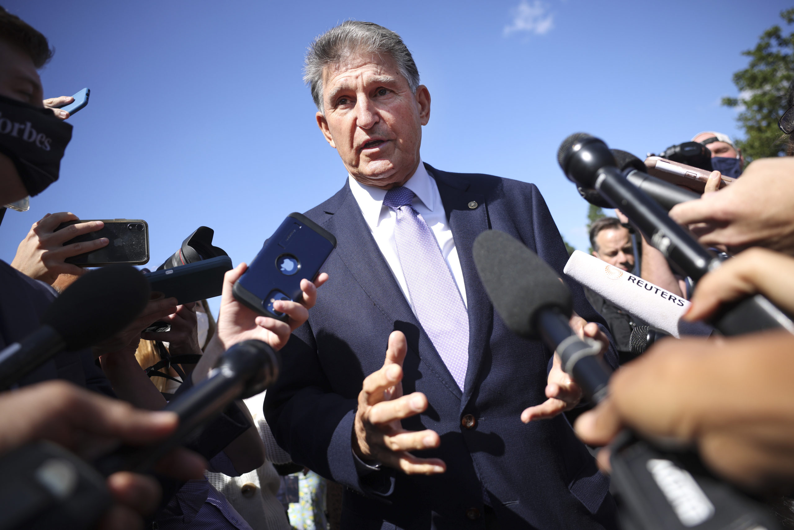 Sen. Joe Manchin speaks to reporters outside of the Capitol on Thursday. (Kevin Dietsch/Getty Images)