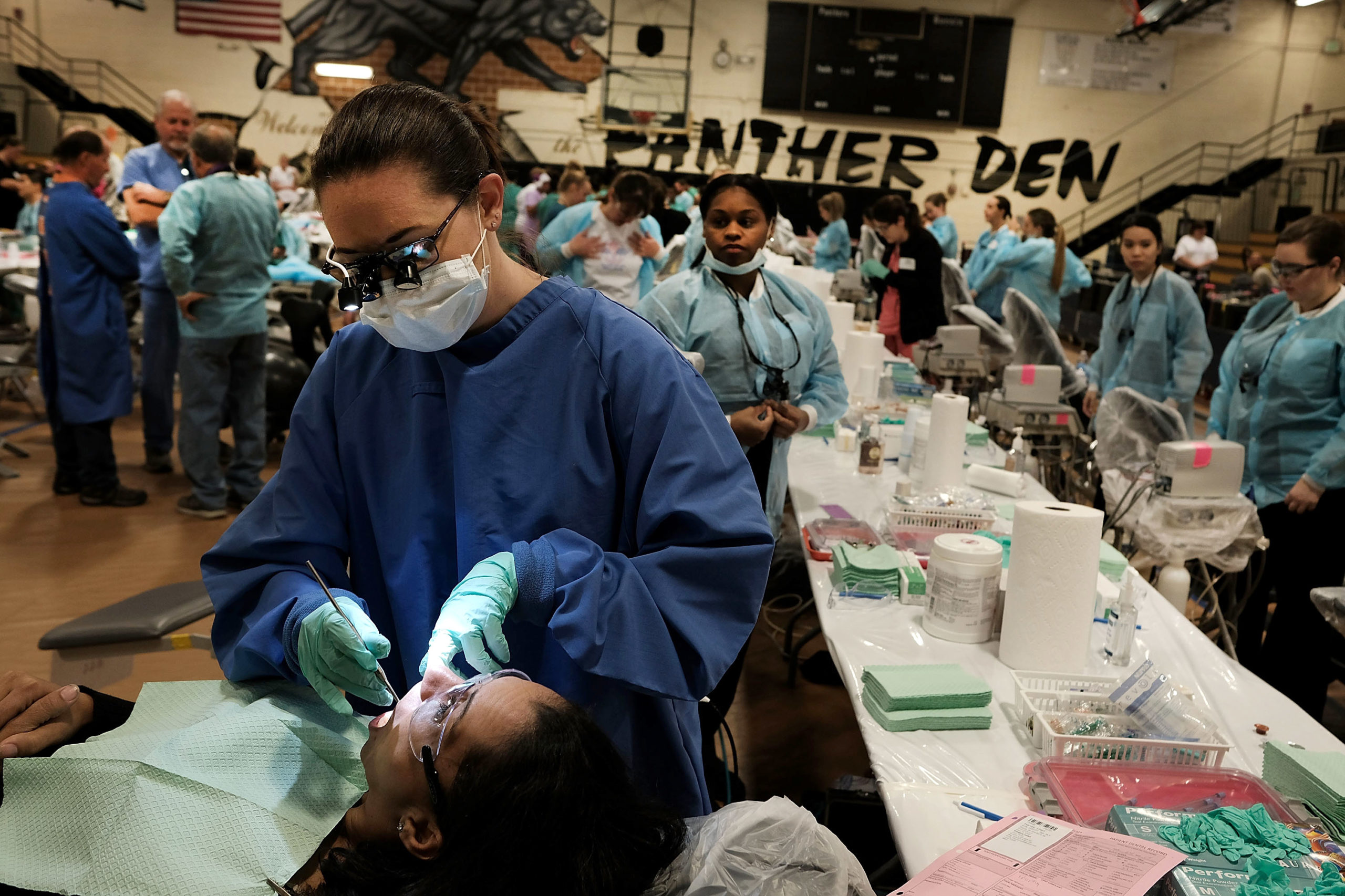 Dentists work on a patient at a remote mobile dental clinic for the poor in 2016 in Milton, Florida. (Spencer Platt/Getty Images)