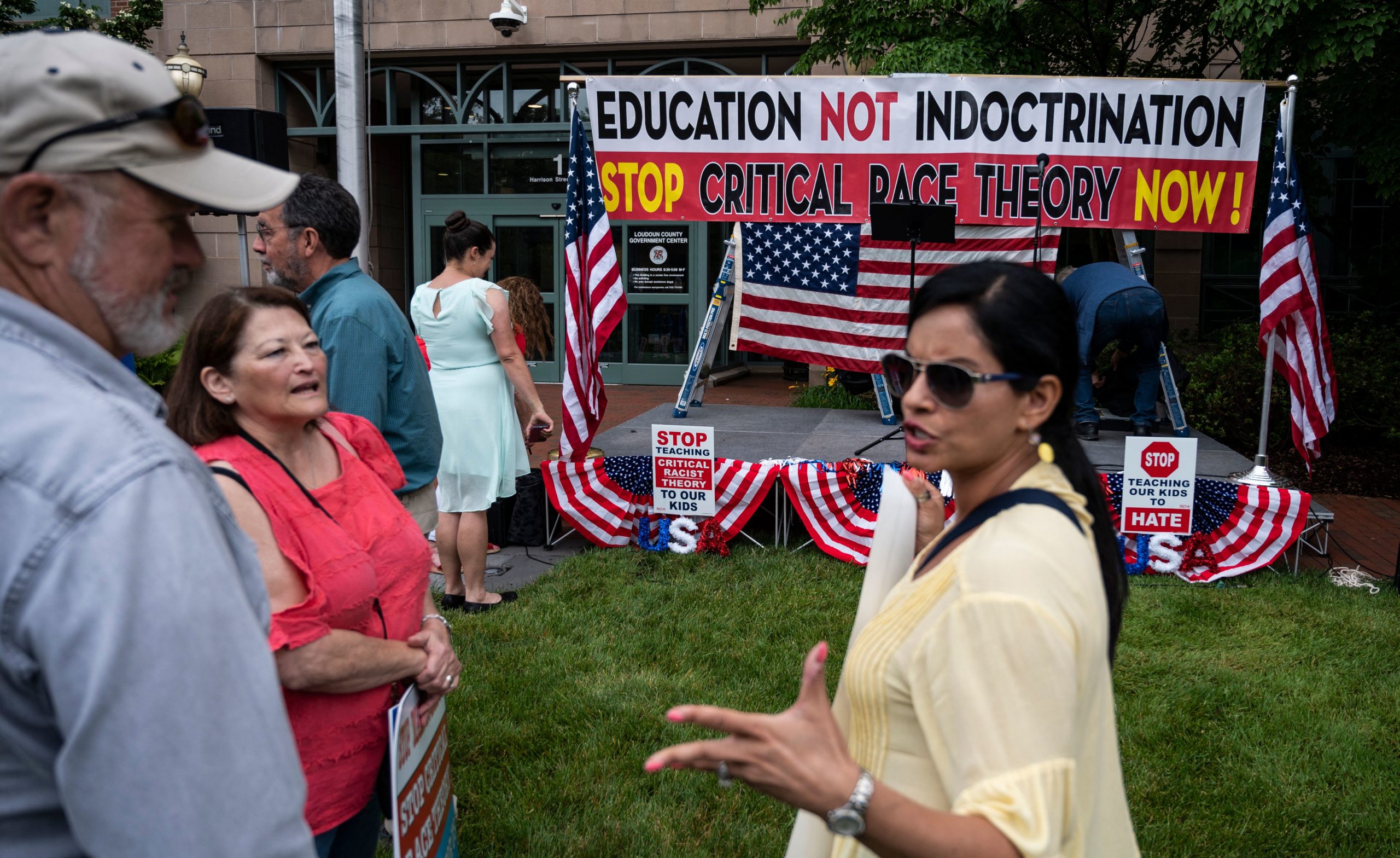 People talk before the start of a rally against "critical race theory" (CRT) being taught in schools at the Loudoun County Government center in Leesburg, Virginia on June 12, 2021. "Are you ready to take back our schools?" Republican activist Patti Menders shouted at a rally opposing anti-racism teaching that critics like her say trains white children to see themselves as "oppressors." "Yes!", answered in unison the hundreds of demonstrators gathered this weekend near Washington to fight against "critical race theory," the latest battleground of America's ongoing culture wars. (Photo by ANDREW CABALLERO-REYNOLDS/AFP via Getty Images)