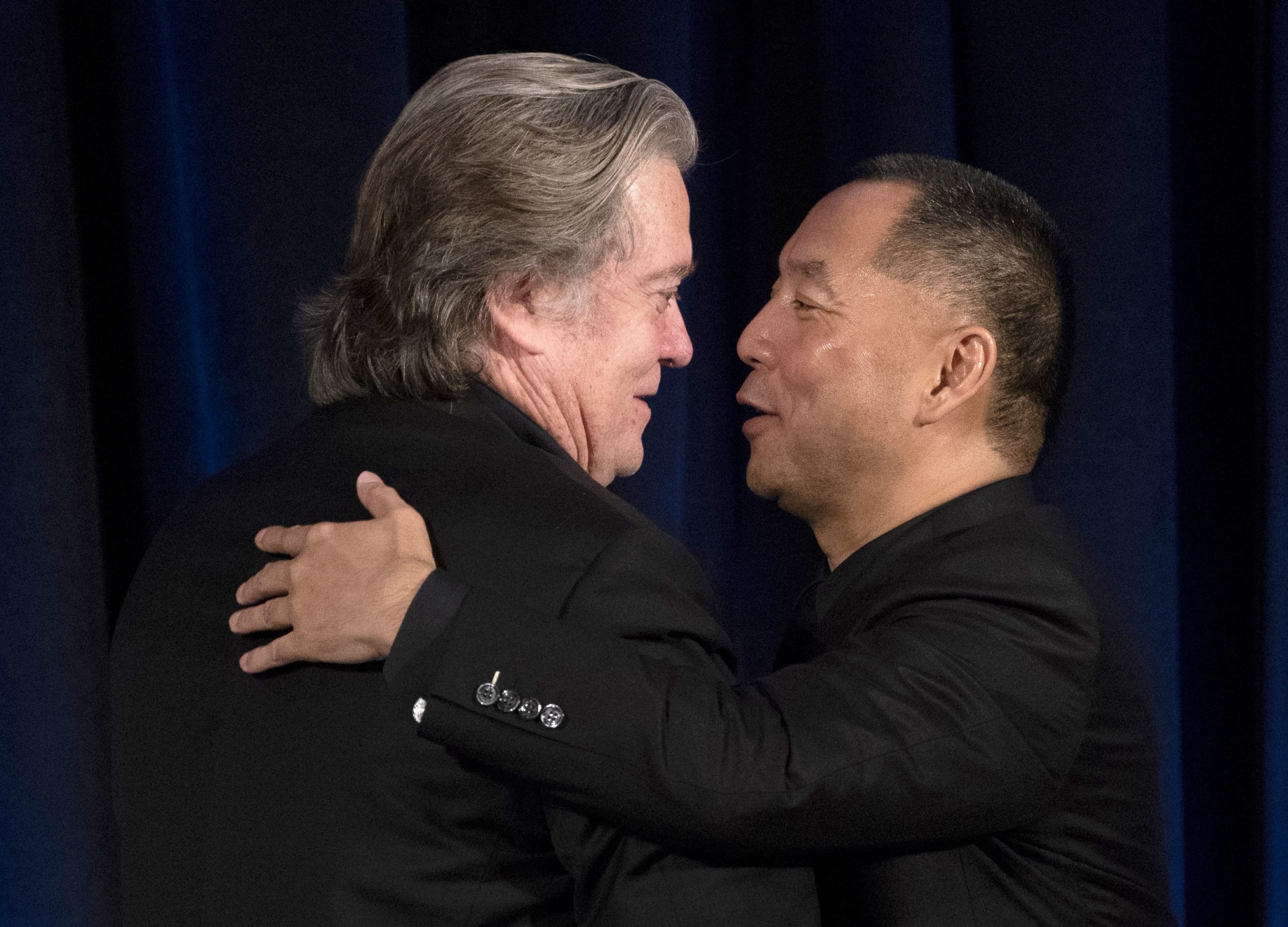 Former White House Chief Strategist Steve Bannon (L) greets fugitive Chinese billionaire Guo Wengui before introducing him at a news conference on November 20, 2018 in New York, on the death of of tycoon Wang Jian in France on July 3, 2018. (Photo by Don EMMERT / AFP via Getty Images)