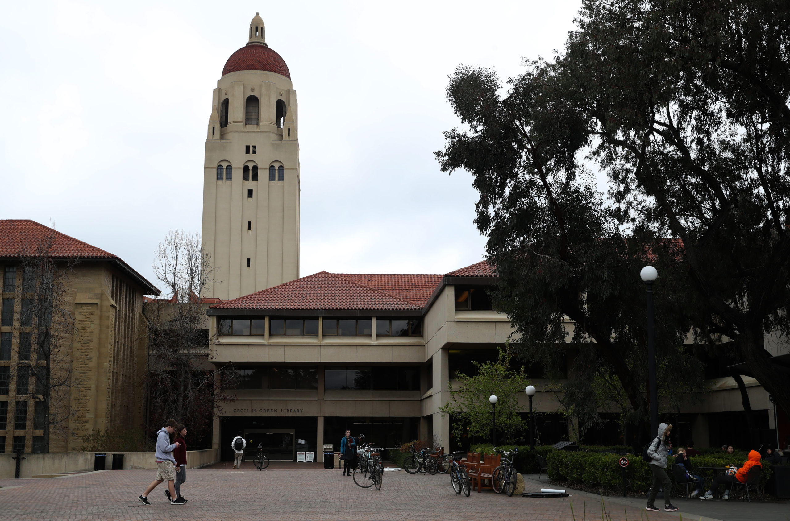People walk by Hoover Tower on the Stanford University campus on March 12, 2019 in Stanford, California. (Photo by Justin Sullivan/Getty Images)