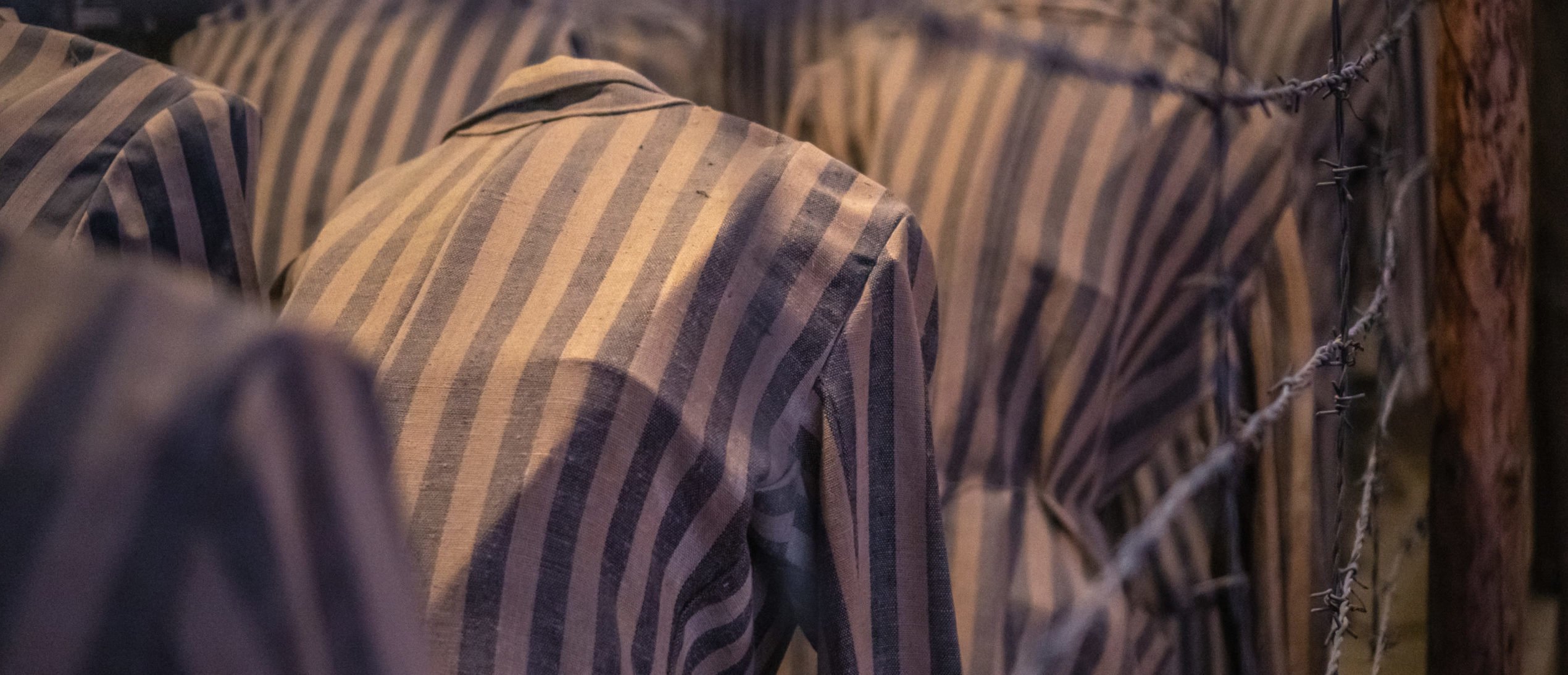 Auschwitz Birkenau, Poland, 05.07.2021.Group of mannequins in stripe clothes, shows how in the terrible conditions people where kept in old nazi concentration camp [Shutterstock/ Lukasz Machowczyk]
