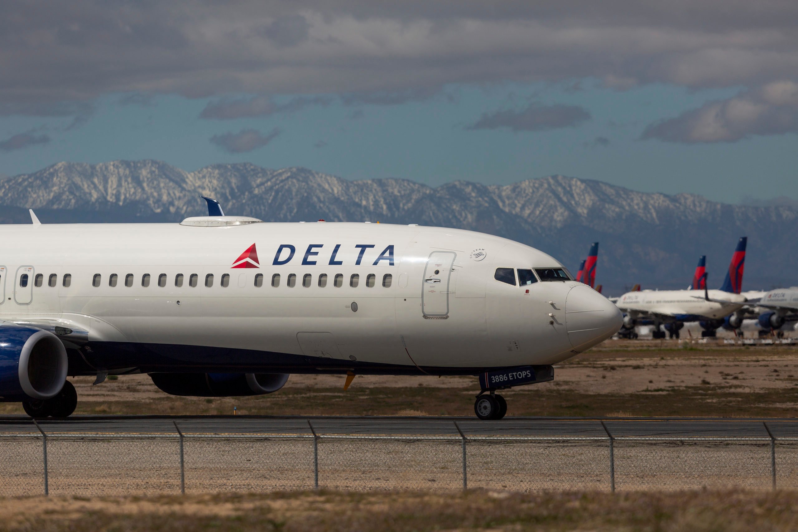 VICTORVILLE, CA - MARCH 24: A Delta Air Lines jet taxis to be parked with a growing number of jets at Southern California Logistics Airport (SCLA) on March 24, 2020 in Victorville, California. As the coronavirus pandemic grows, exponentially increasing travel restrictions and the numbers of people in quarantine, airlines around the world are scrambling to find places to park a majority of their fleet as they wait to see how the situation will play out. (Photo by David McNew/Getty Images)