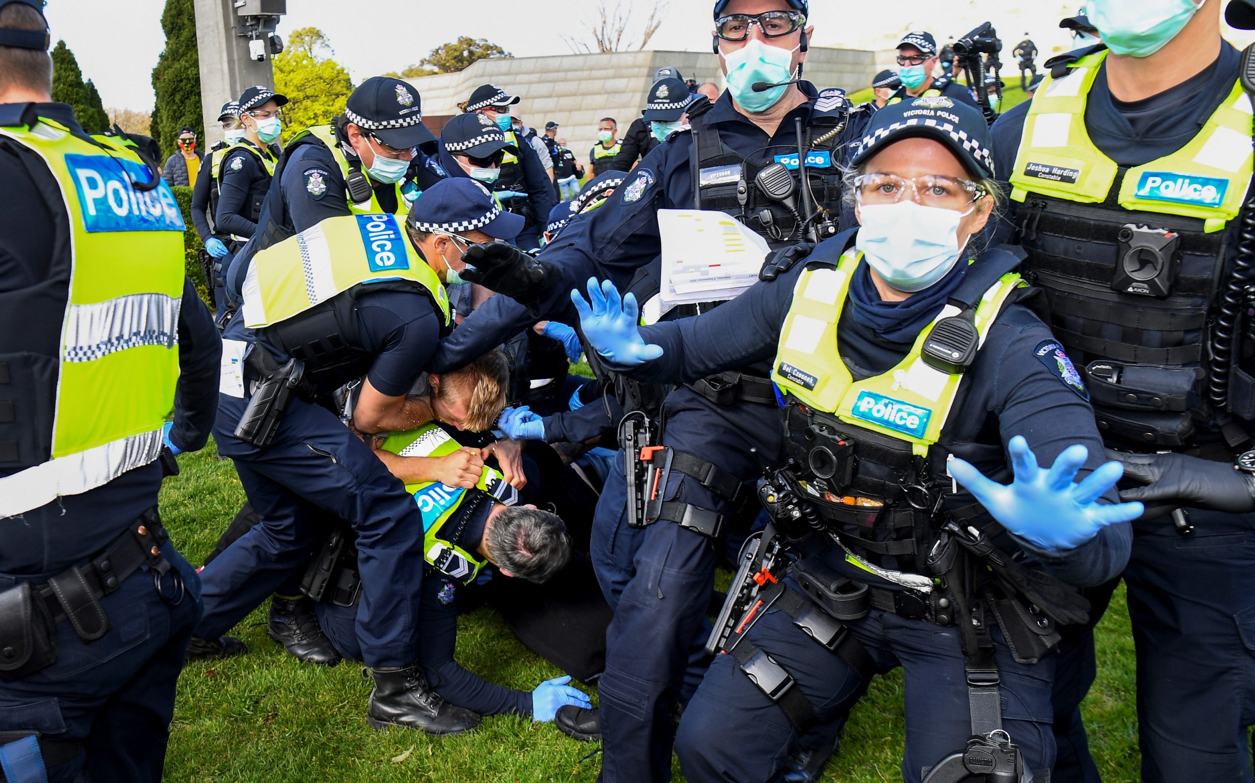 TOPSHOT - Police tackle protesters in Melbourne on September 5, 2020 during an anti-lockdown rally protesting the state's strict lockdown laws as a preventive measure against the COVID-19 coronavirus. (Photo by William WEST / AFP) (Photo by WILLIAM WEST/AFP via Getty Images)