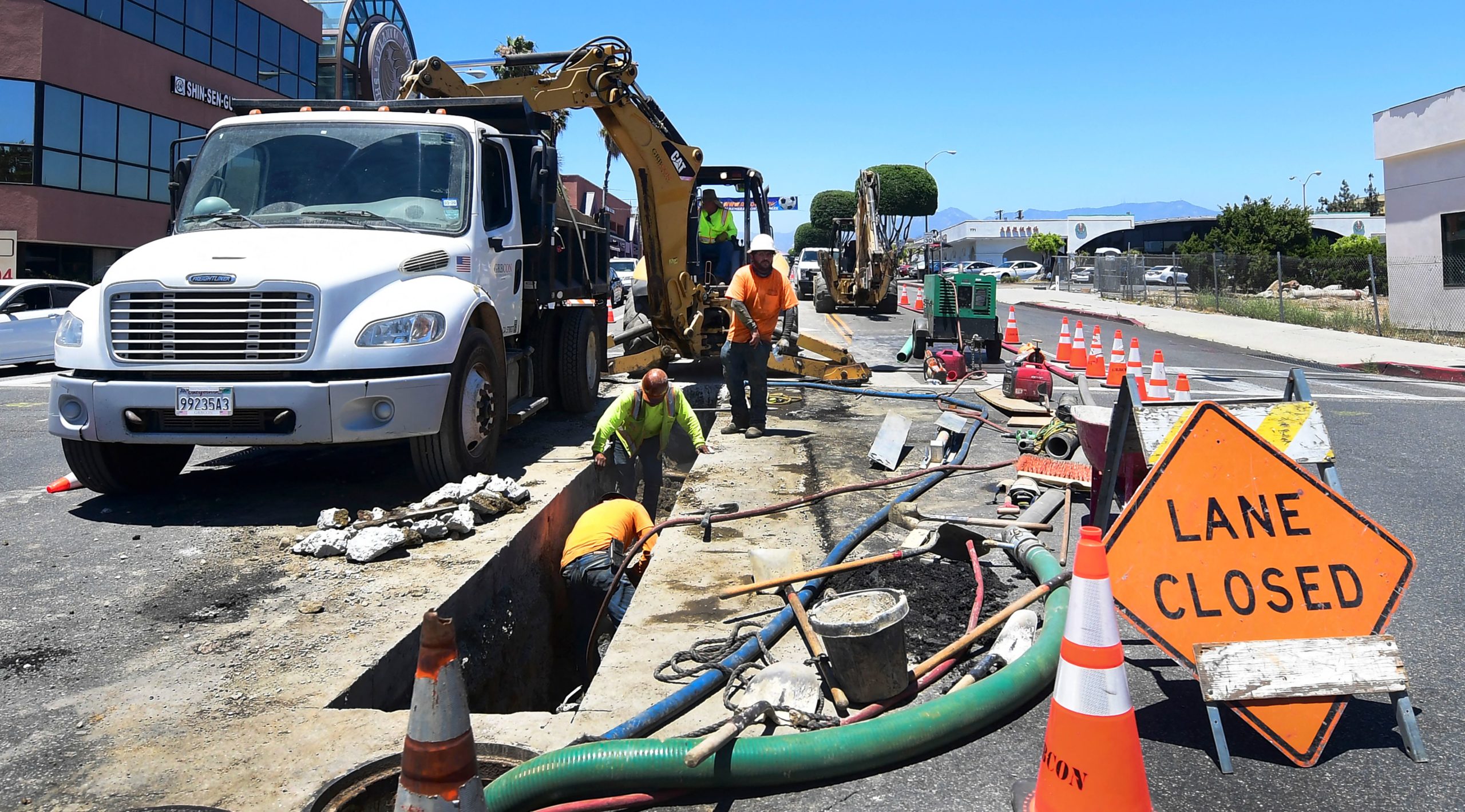 A roadworks crew work in Monterey Park, California on June 24. (Frederic J. Brown/AFP via Getty Images)