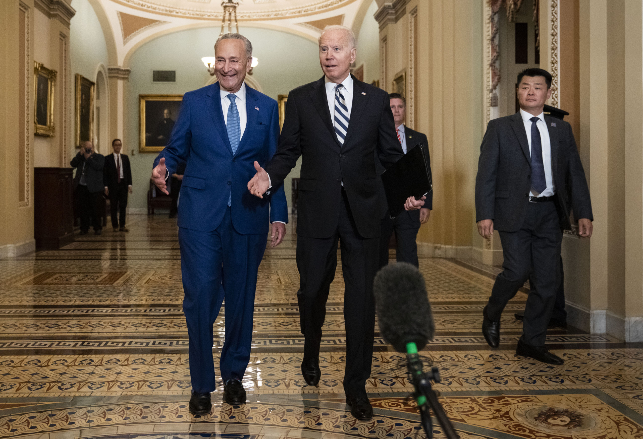 WASHINGTON, DC - JULY 14: (EDITOR'S NOTE: Alternate crop) Senate Majority Leader Chuck Schumer (D-NY) and U.S. President Joe Biden speak briefly to reporters as they arrive at the U.S. Capitol for a Senate Democratic luncheon July 14, 2021 in Washington, DC. President Biden is on the Hill to discuss with Senate Democrats the $3.5 trillion reconciliation package they have reached overnight that would expand Medicare benefits, boost federal safety net programs and combat climate change. (Photo by Drew Angerer/Getty Images)