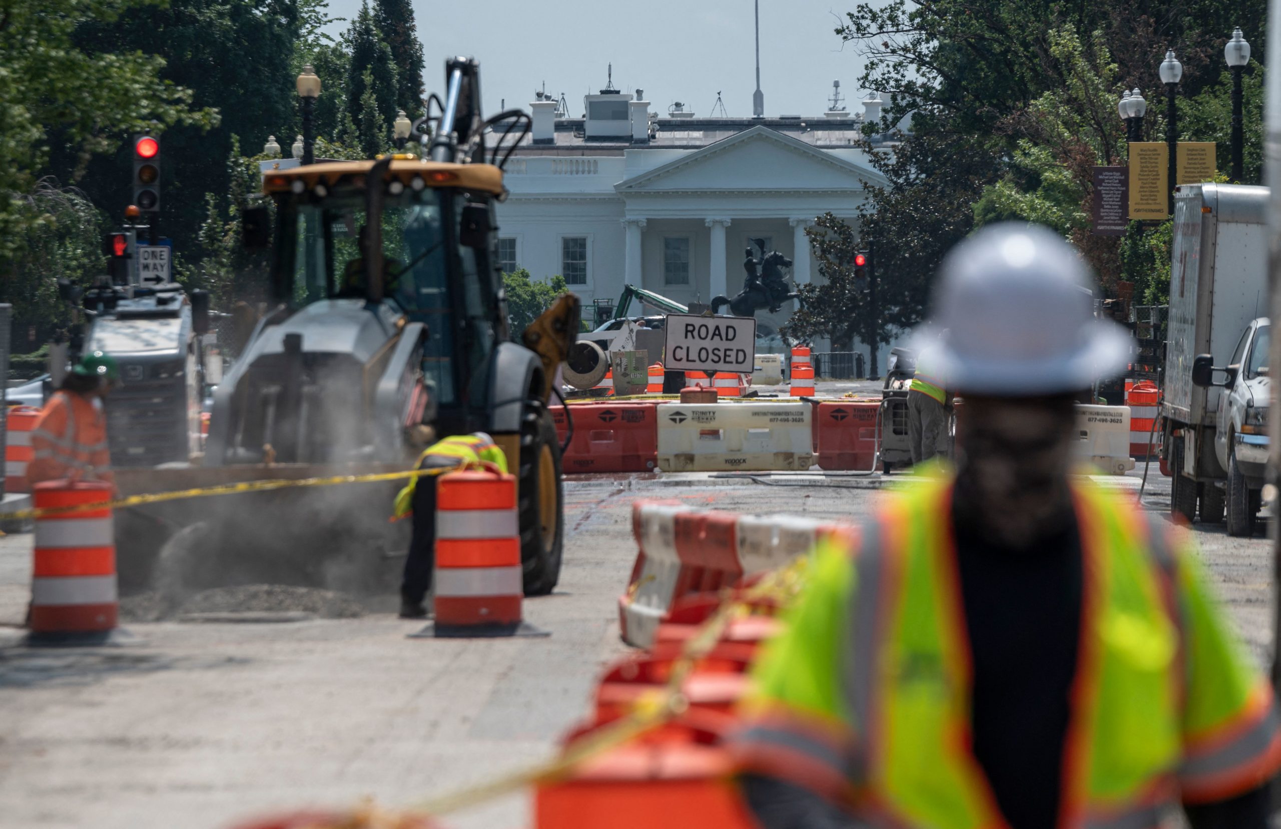Construction workers repair a street near the White House in Washington, D.C. on Aug. 10. (Andrew Caballero-Reynolds/AFP via Getty Images)