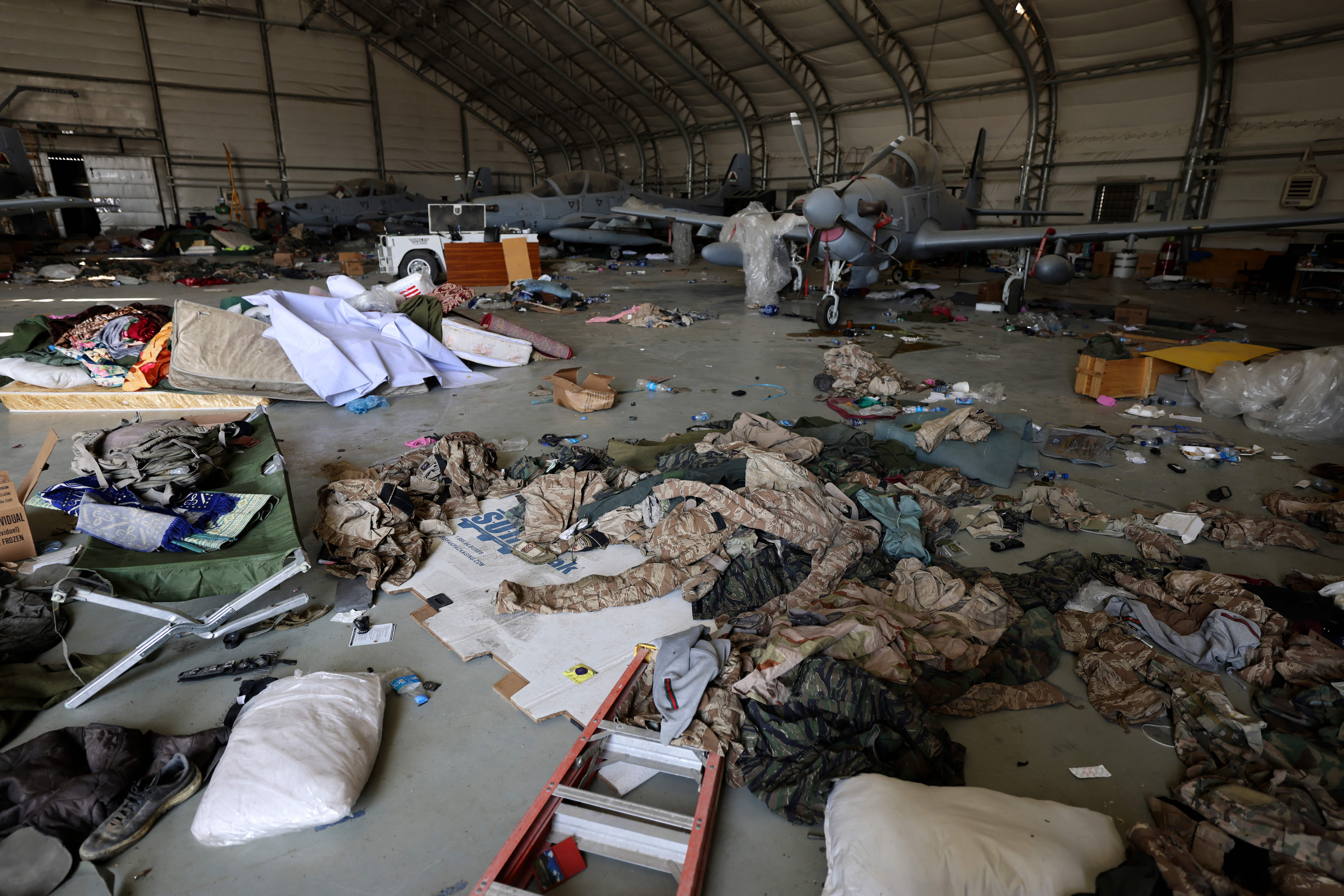 Army clothing is seen scattered next to Afghan Air Force aircrafts inside a hangar at the airport in Kabul on September 14, 2021. (Photo by Karim SAHIB / AFP) (Photo by KARIM SAHIB/AFP via Getty Images)