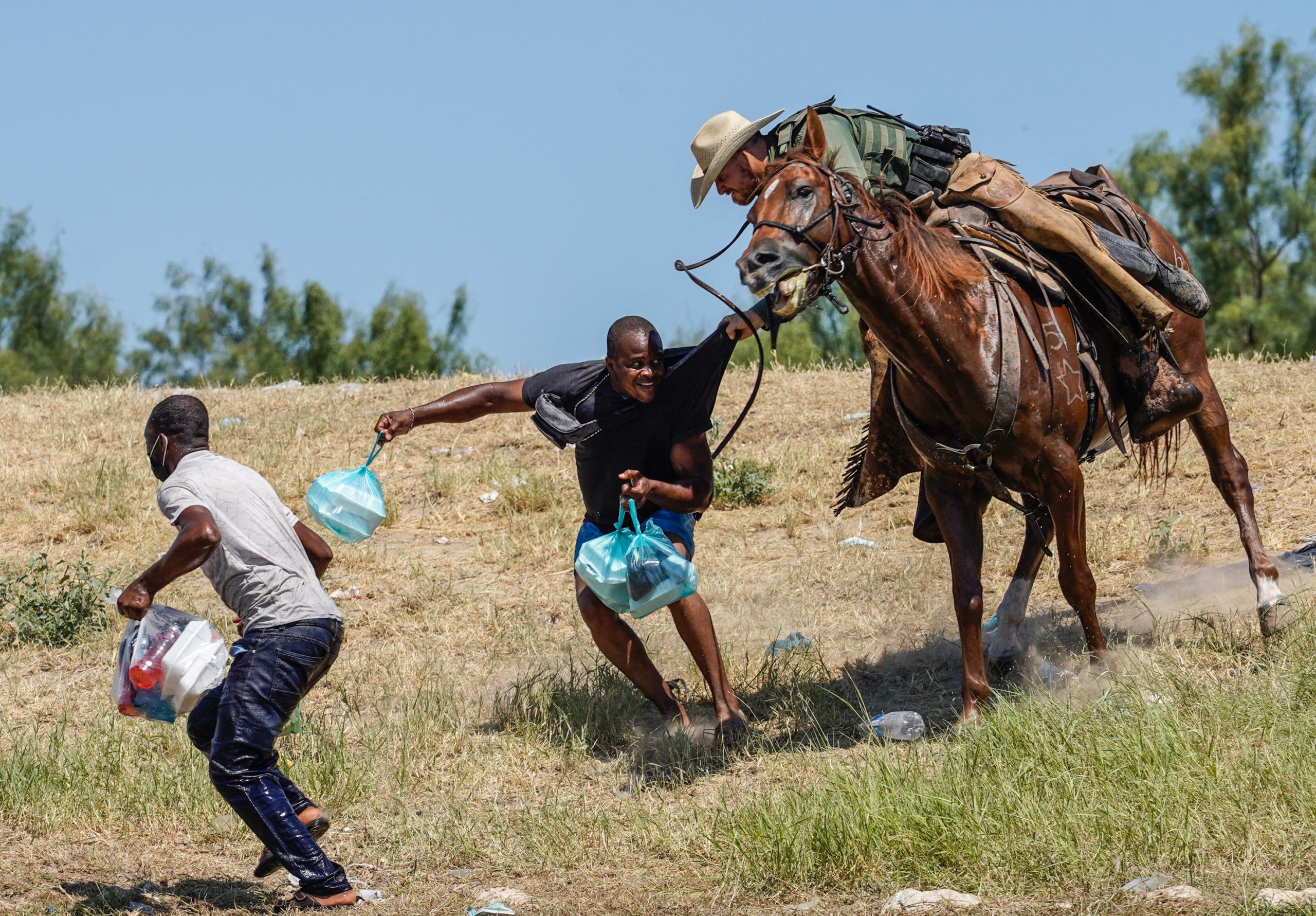 A United States Border Patrol agent on horseback tries to stop a Haitian migrant from entering an encampment on the banks of the Rio Grande near the Acuna Del Rio International Bridge in Del Rio, Texas on September 19, 2021. (Photo by PAUL RATJE / AFP) (Photo by PAUL RATJE/AFP via Getty Images