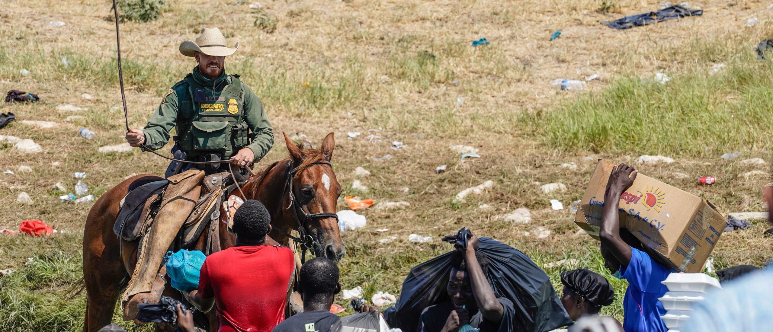 TOPSHOT - A United States Border Patrol agent on horseback uses the reins as he tries to stop Haitian migrants from entering an encampment on the banks of the Rio Grande near the Acuna Del Rio International Bridge in Del Rio, Texas on September 19, 2021. - The United States said Saturday it would ramp up deportation flights for thousands of migrants who flooded into the Texas border city of Del Rio, as authorities scramble to alleviate a burgeoning crisis for President Joe Biden's administration. (Photo by PAUL RATJE / AFP) (Photo by PAUL RATJE/AFP via Getty Images)