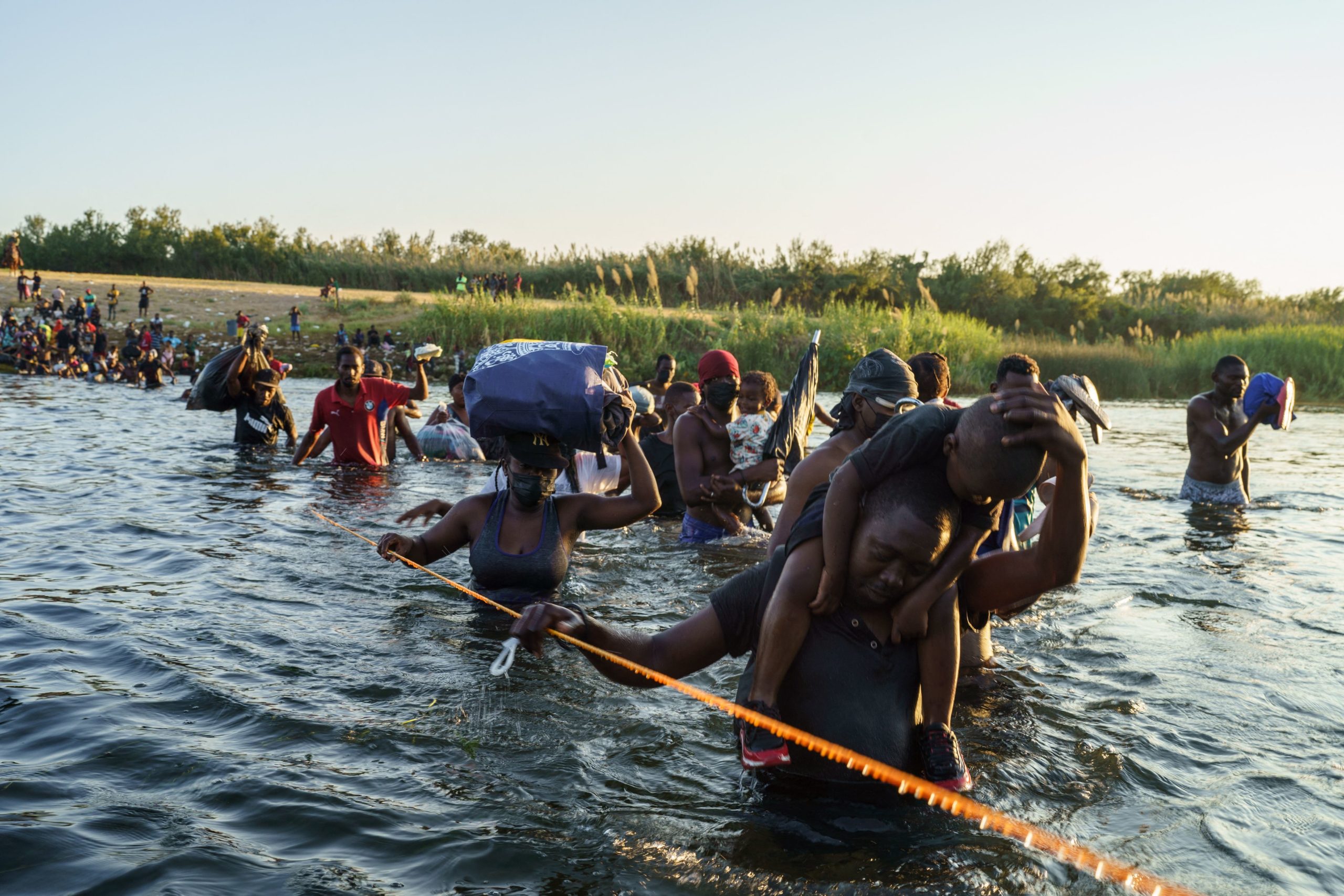 Haitian migrants continue to cross across the US-Mexico border on the Rio Grande as seen from Ciudad Acuna, Coahuila state, Mexico on September 20, 2021. (Photo by PAUL RATJE/AFP via Getty Images)