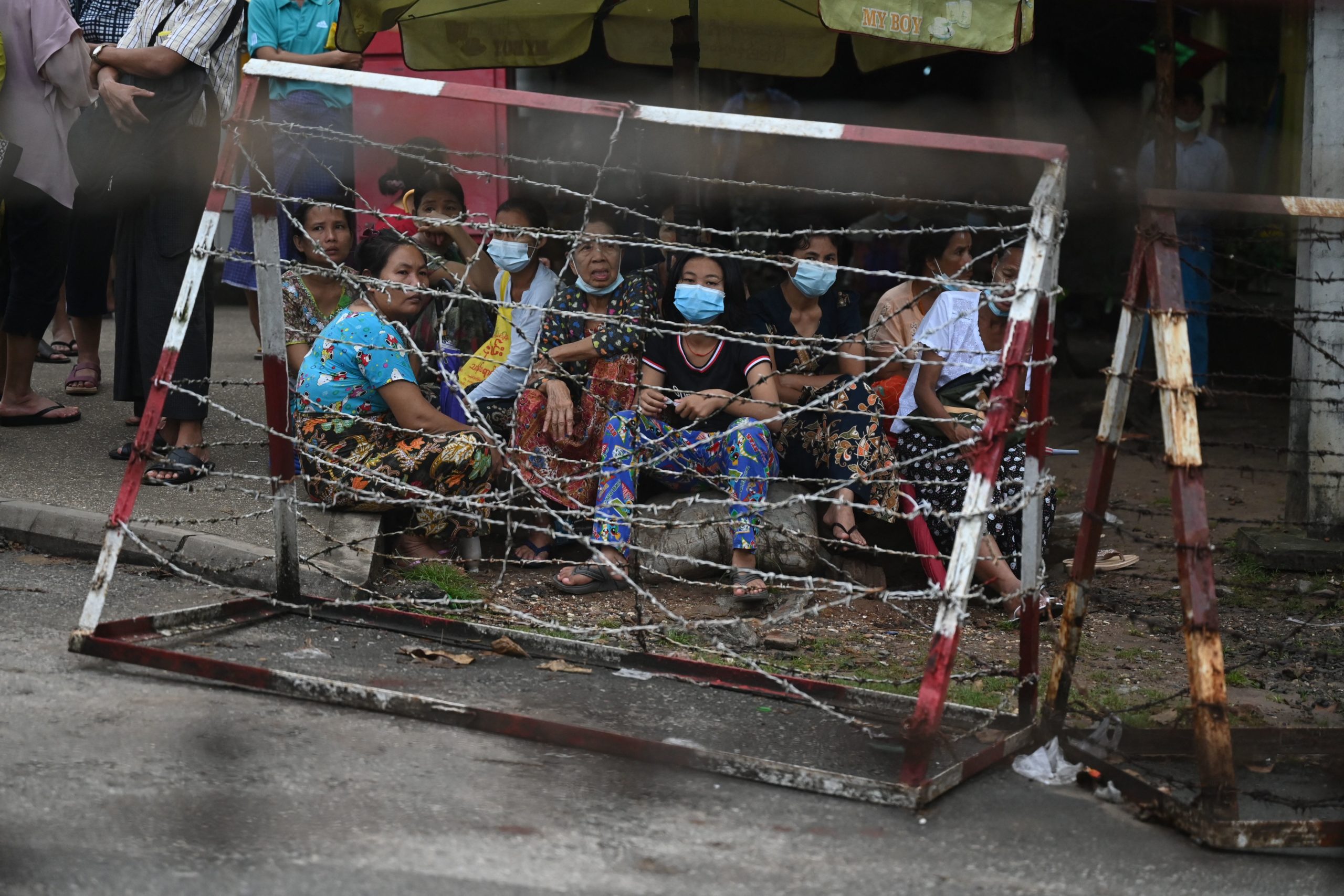 People wait outside Insein Prison in Yangon on October 18, 2021, as authorities announced more than 5,000 people jailed for protesting against a February coup which ousted the civilian government would be released. (Photo by AFP) (Photo by STR/AFP via Getty Images)