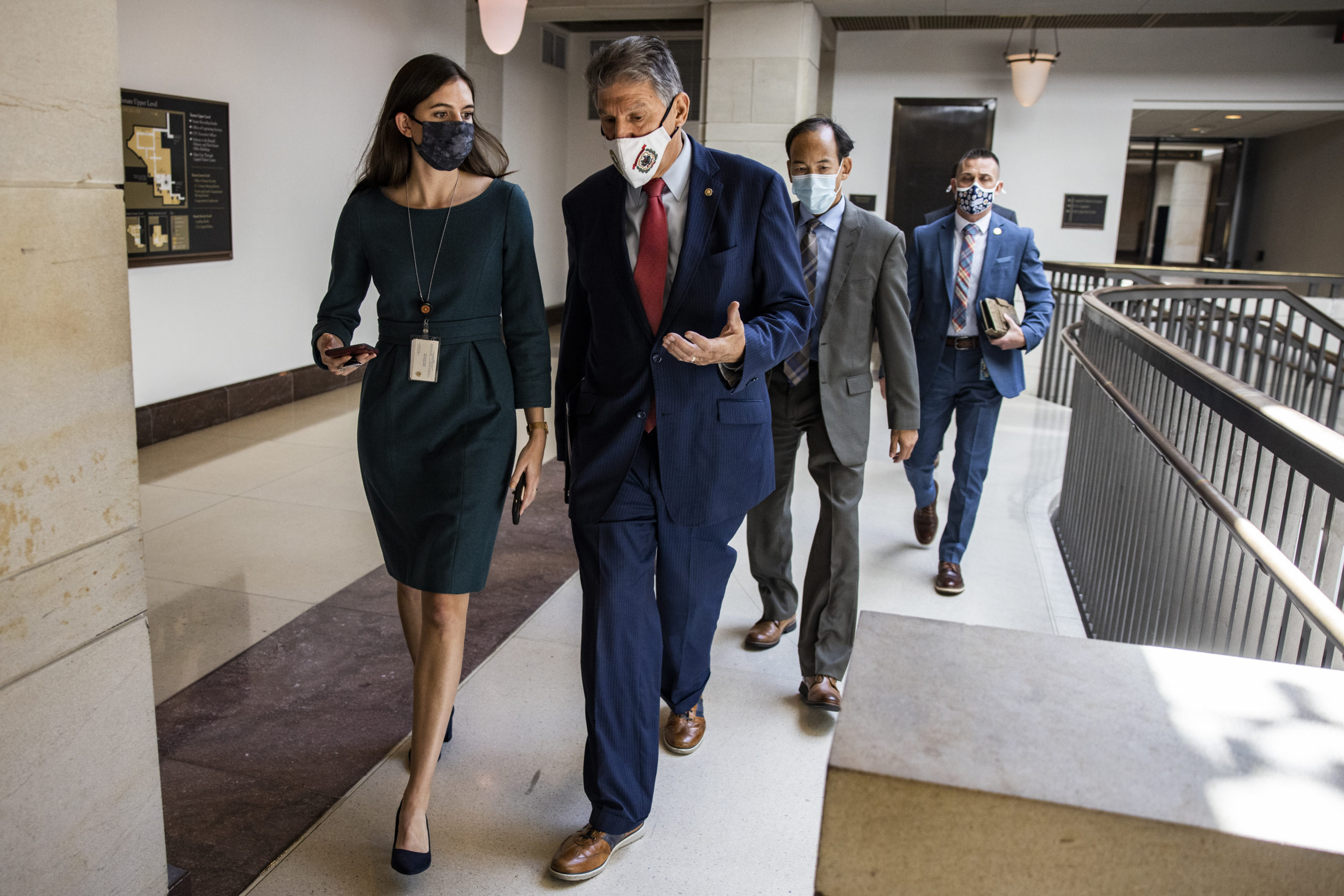 Sen. Joe Manchin walks through the Capitol on Tuesday. (Samuel Corum/Getty Images)