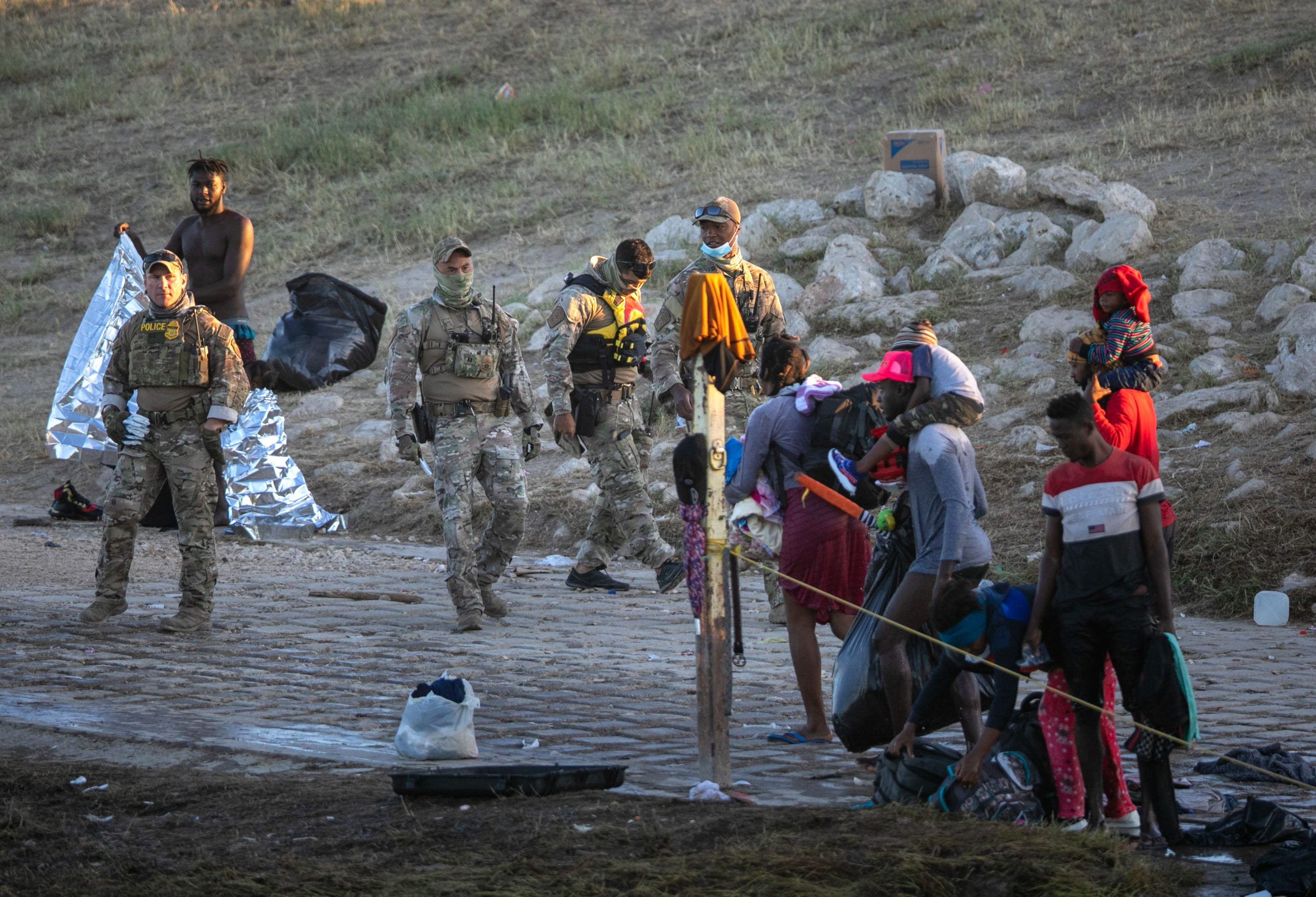 U.S. Border Patrol agents look on after Haitian immigrant families crossed the Rio Grande to Del Rio, Texas on September 23, 2021, from Ciudad Acuna, Mexico. (Photo by John Moore/Getty Images)