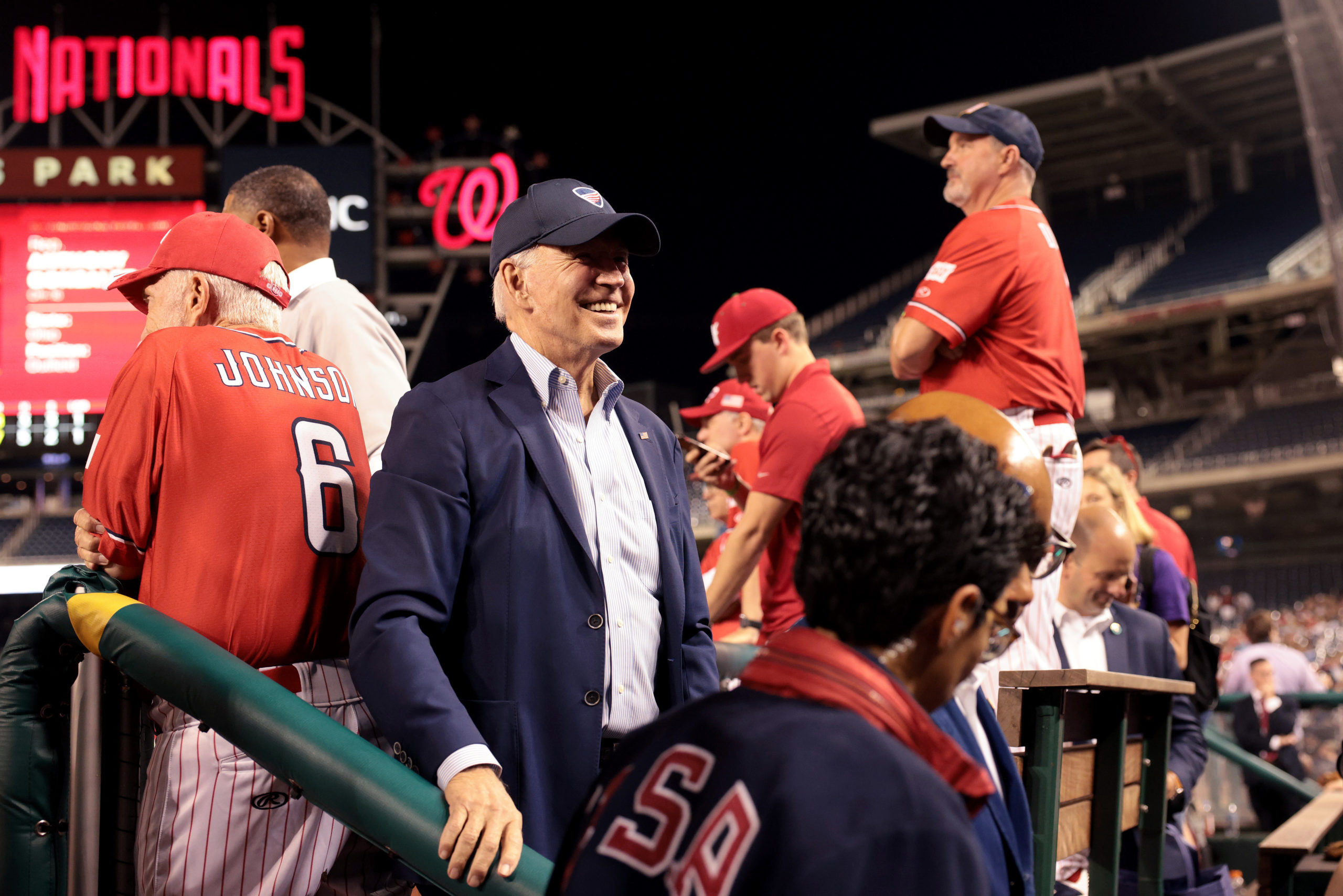 President Joe Biden visits the Republican dugout during the Congressional baseball game at Nationals Park on Wednesday. (Win McNamee/Getty Images)