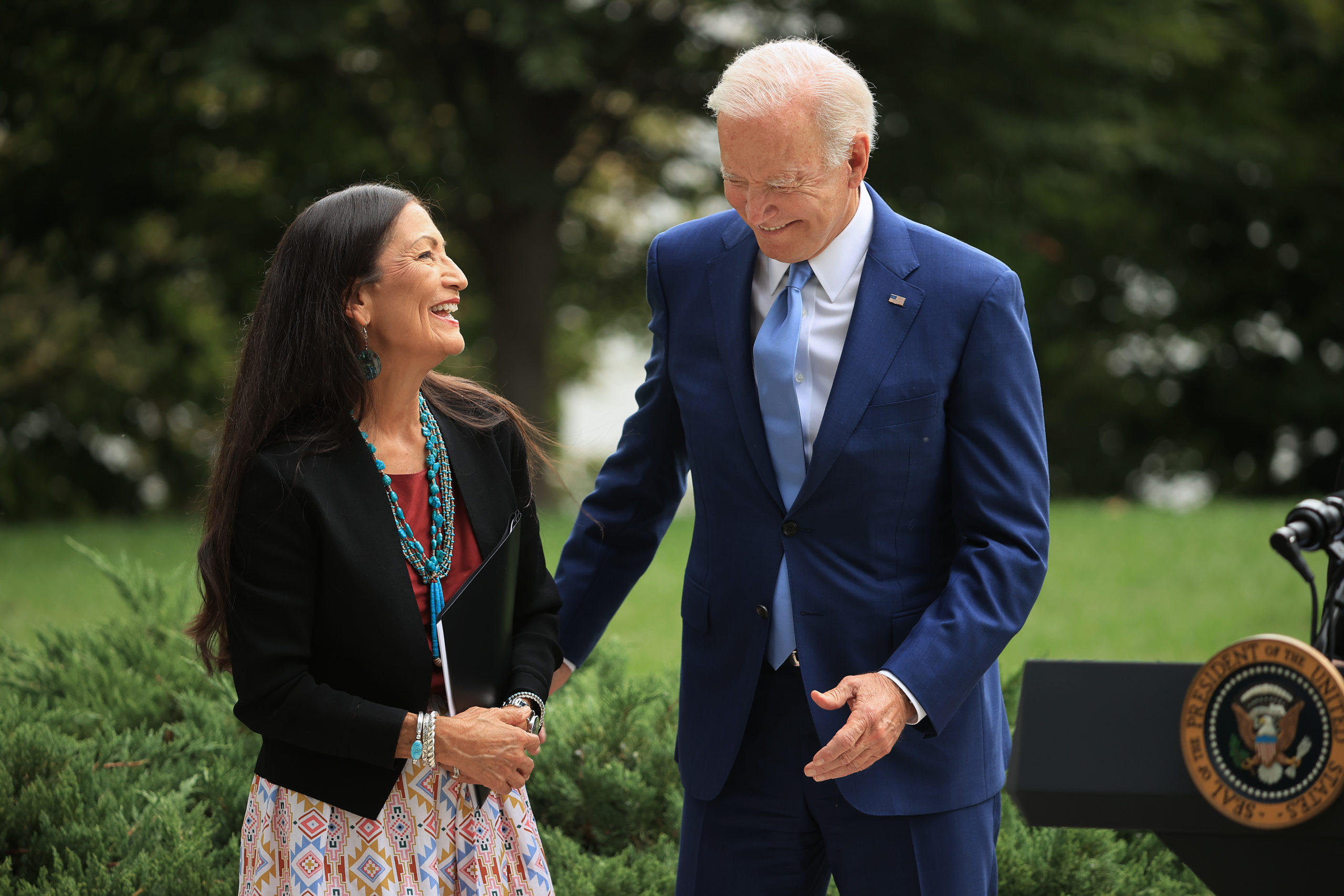 President Joe Biden and Secretary of the Interior Deb Haaland laugh during a ceremony at the White House on Oct. 8. (Chip Somodevilla/Getty Images)