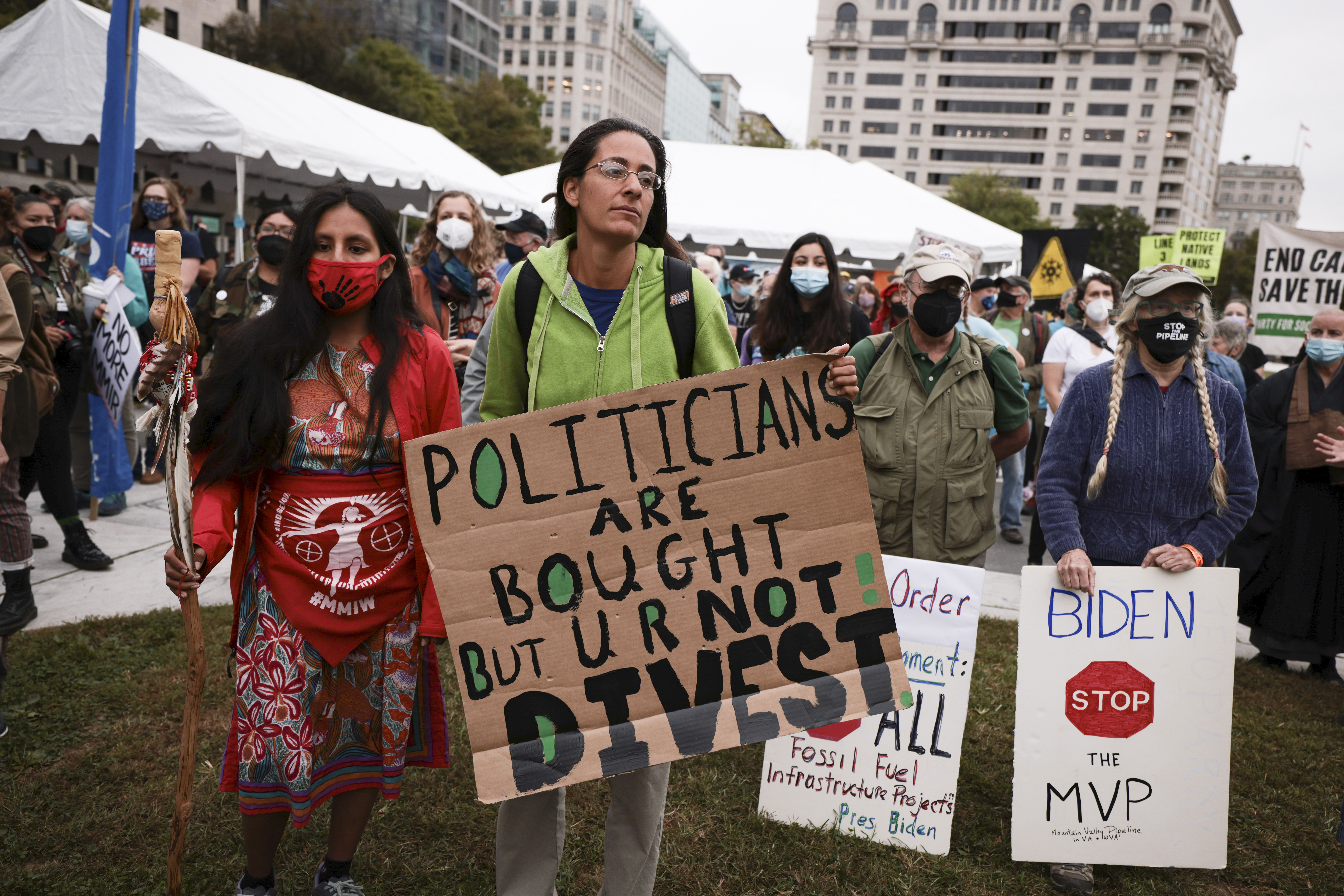 Demonstrators hold signs as they listen to speakers during a climate march on Oct. 11. (Anna Moneymaker/Getty Images)