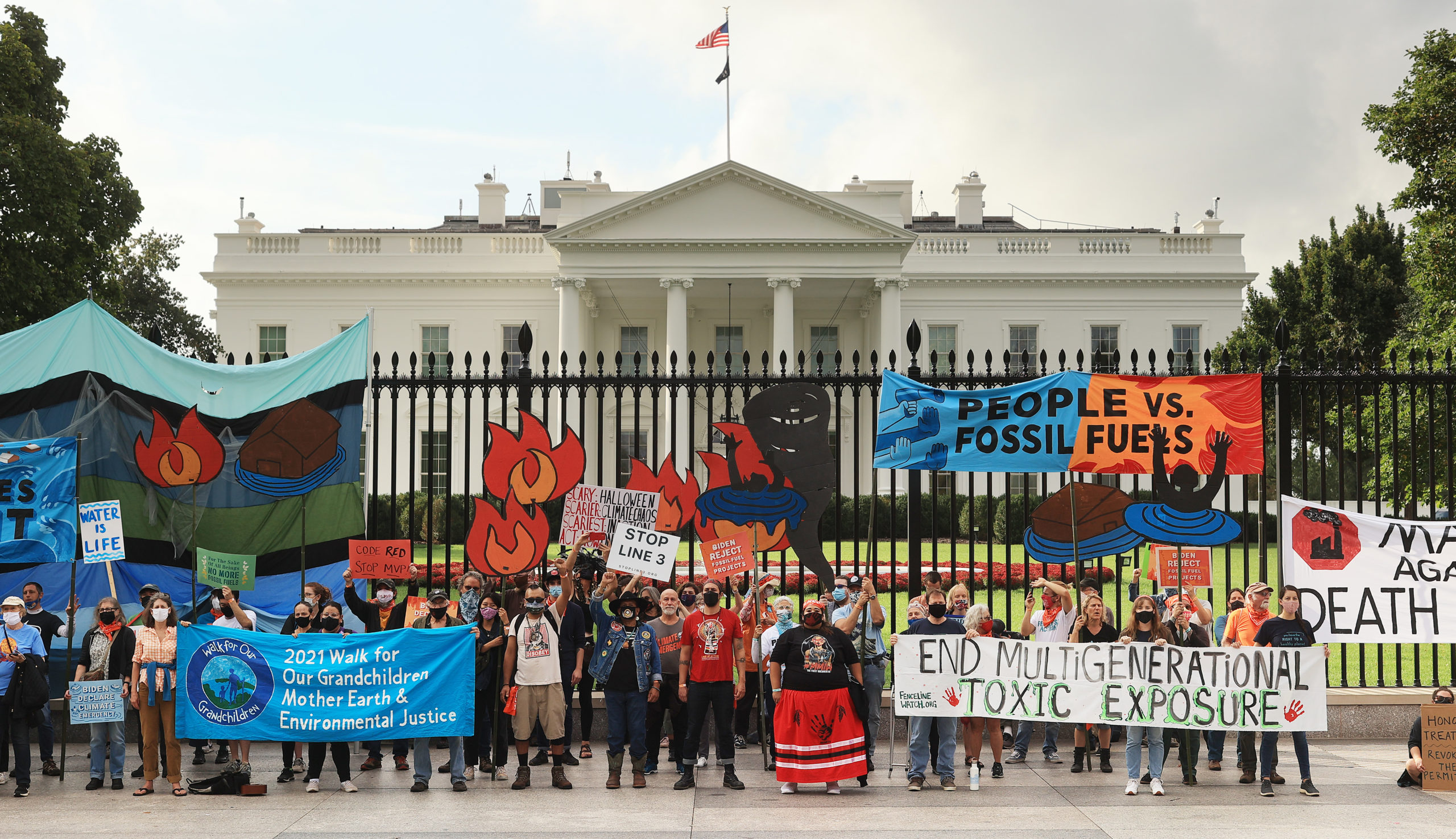 Demonstrators prepare to be arrested during a rally outside the White House on Oct. 13. (Chip Somodevilla/Getty Images)