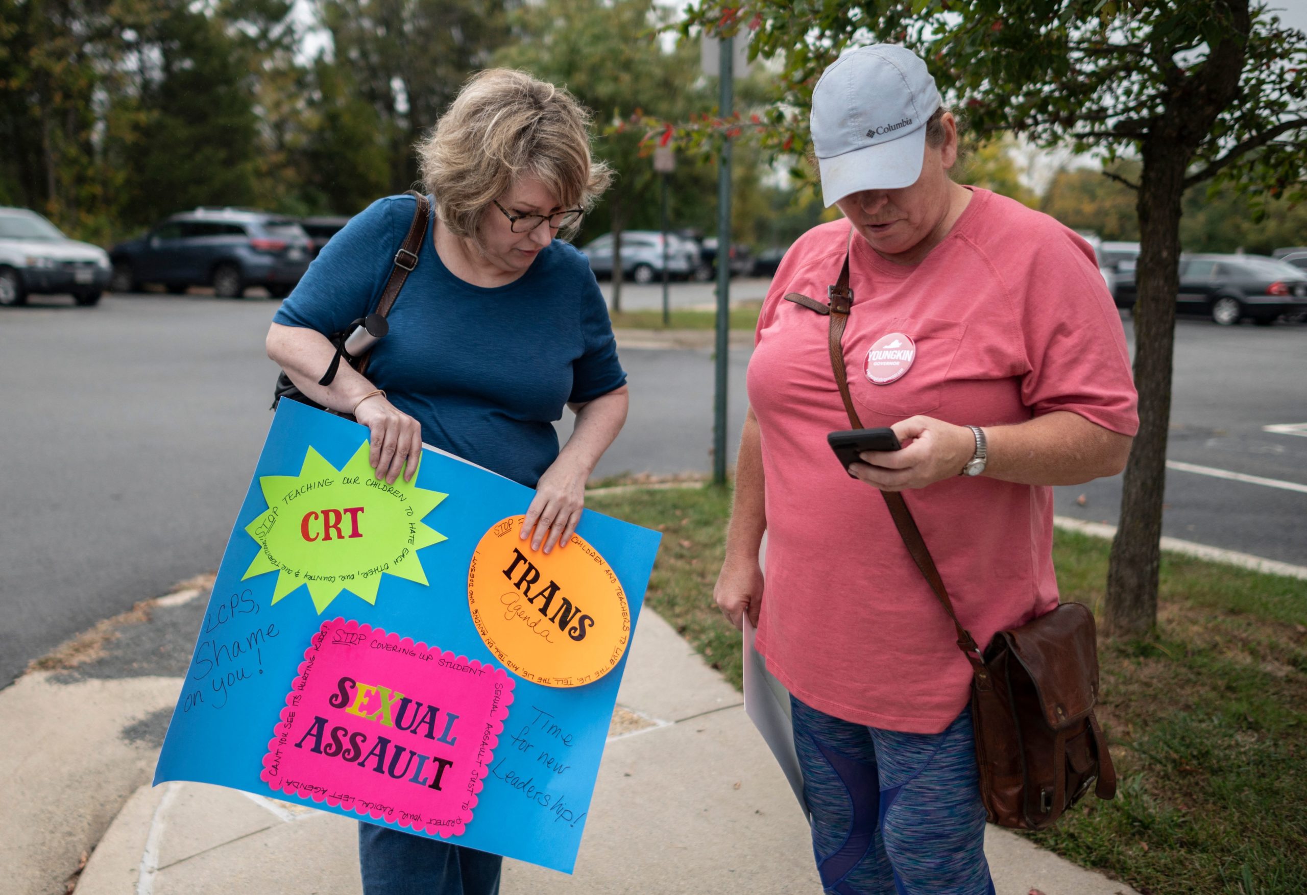 Protesters and activists stand outside a Loudoun County Public Schools (LCPS) board meeting in Ashburn, Virginia on October 12, 2021. (Photo by ANDREW CABALLERO-REYNOLDS/AFP via Getty Images)