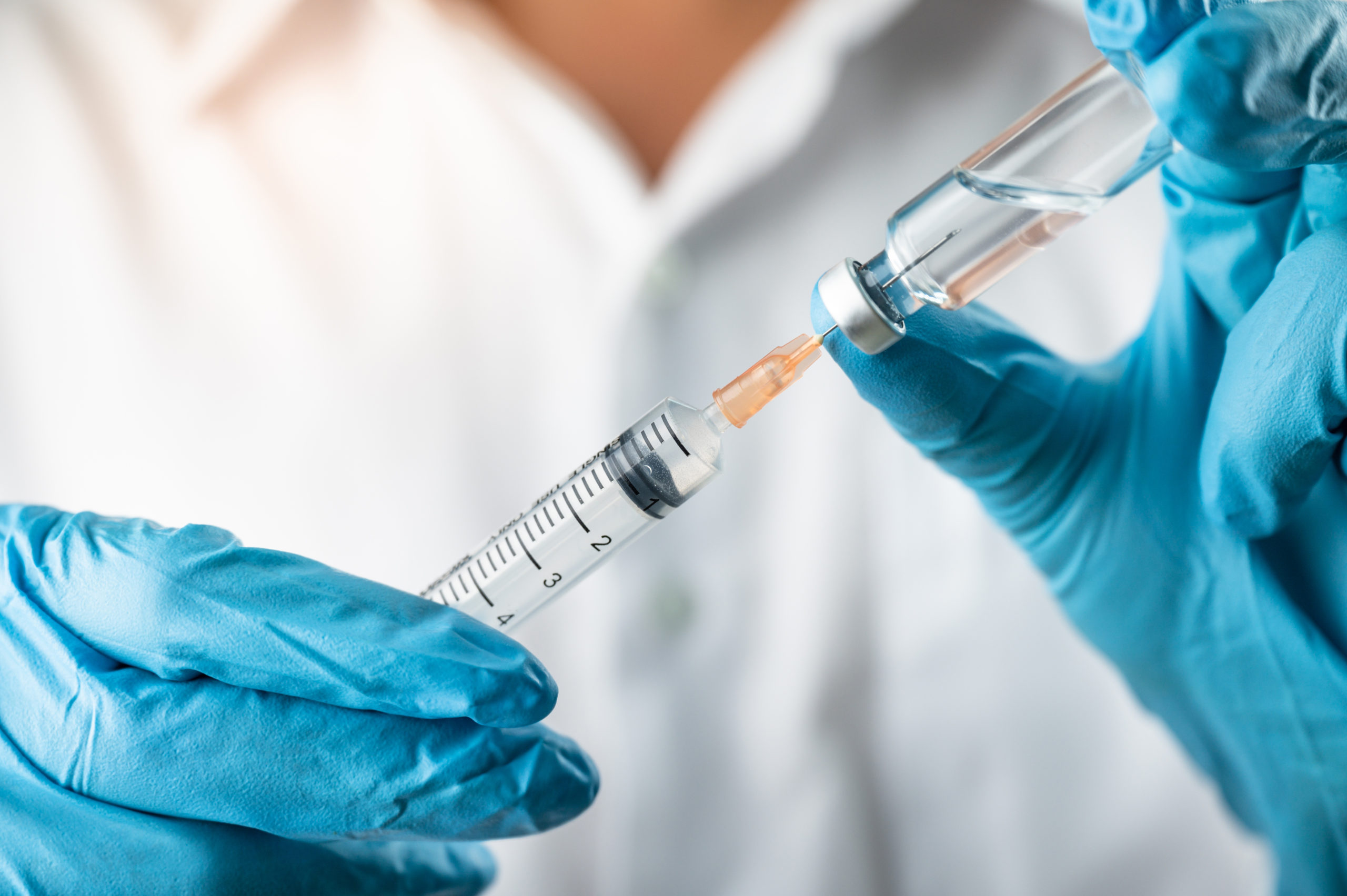 Doctor holds a coronavirus vaccine vial [Shutterstock/PhotobyTawat]