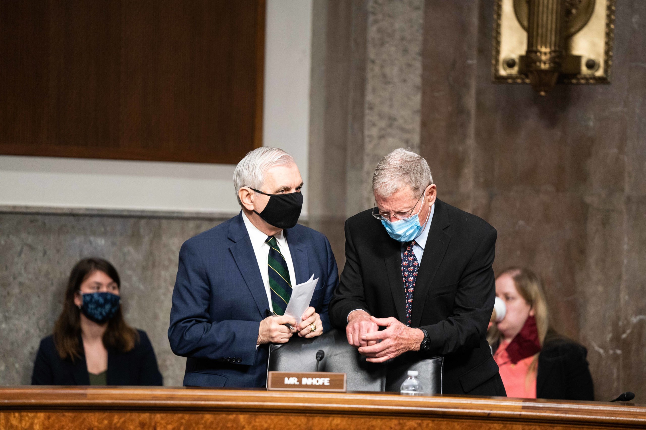 Sens. Jack Reed and Jim Inhofe, the top two senators on the Senate Armed Services Committee talk prior to a hearing on the NDAA in March. (Anna Moneymaker-Pool/Getty Images)