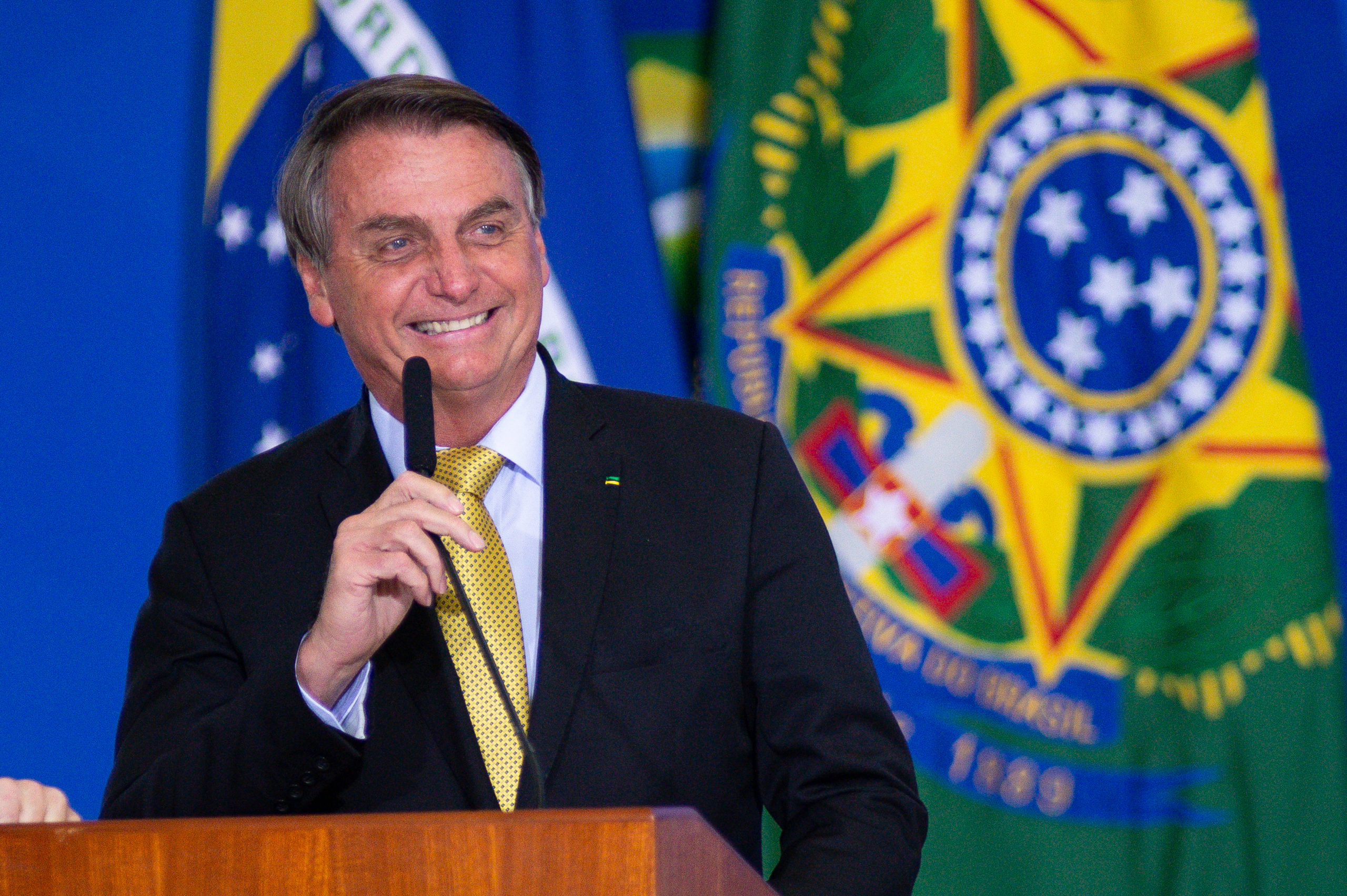 President of Brazil Jair Bolsonaro smiles during an event to launch a new register for professional workers of the fish industry at Planalto Government Palace on June 29, 2021 in Brasilia, Brazil. (Photo by Andressa Anholete/Getty Images)
