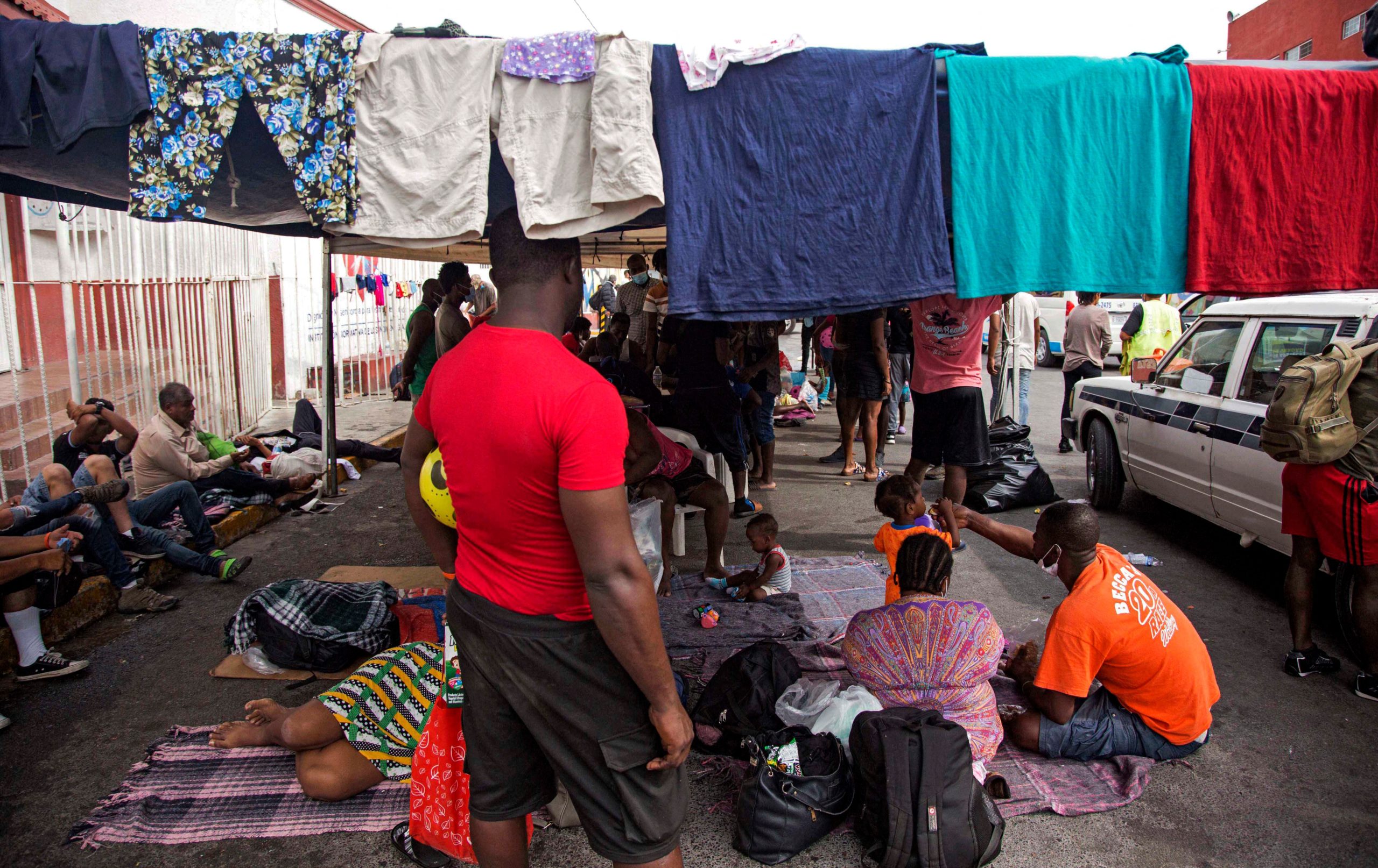 Haitian migrants remain outside a migrant shelter awaiting their immigration resolution, in Monterrey, Mexico, on September 26, 2021. (Photo by JULIO CESAR AGUILAR/AFP via Getty Images)