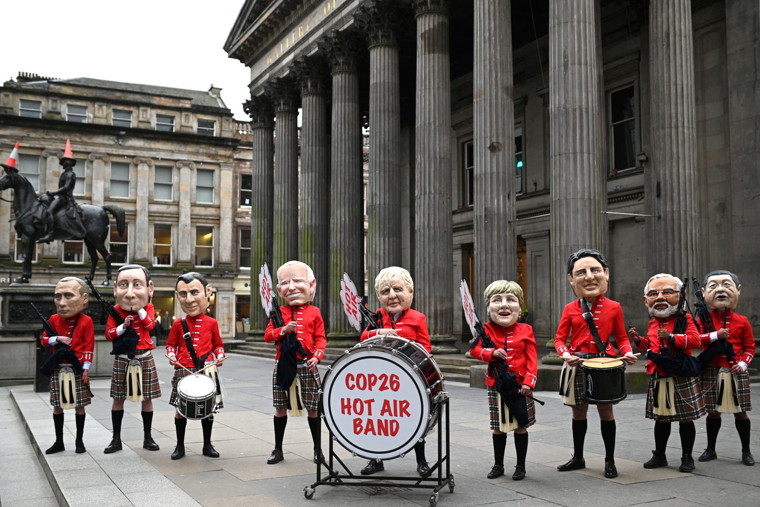 Activists dressed as a Scottish pipe band stage a protest at COP26 on Monday. (Oli Scarff/AFP via Getty Images)