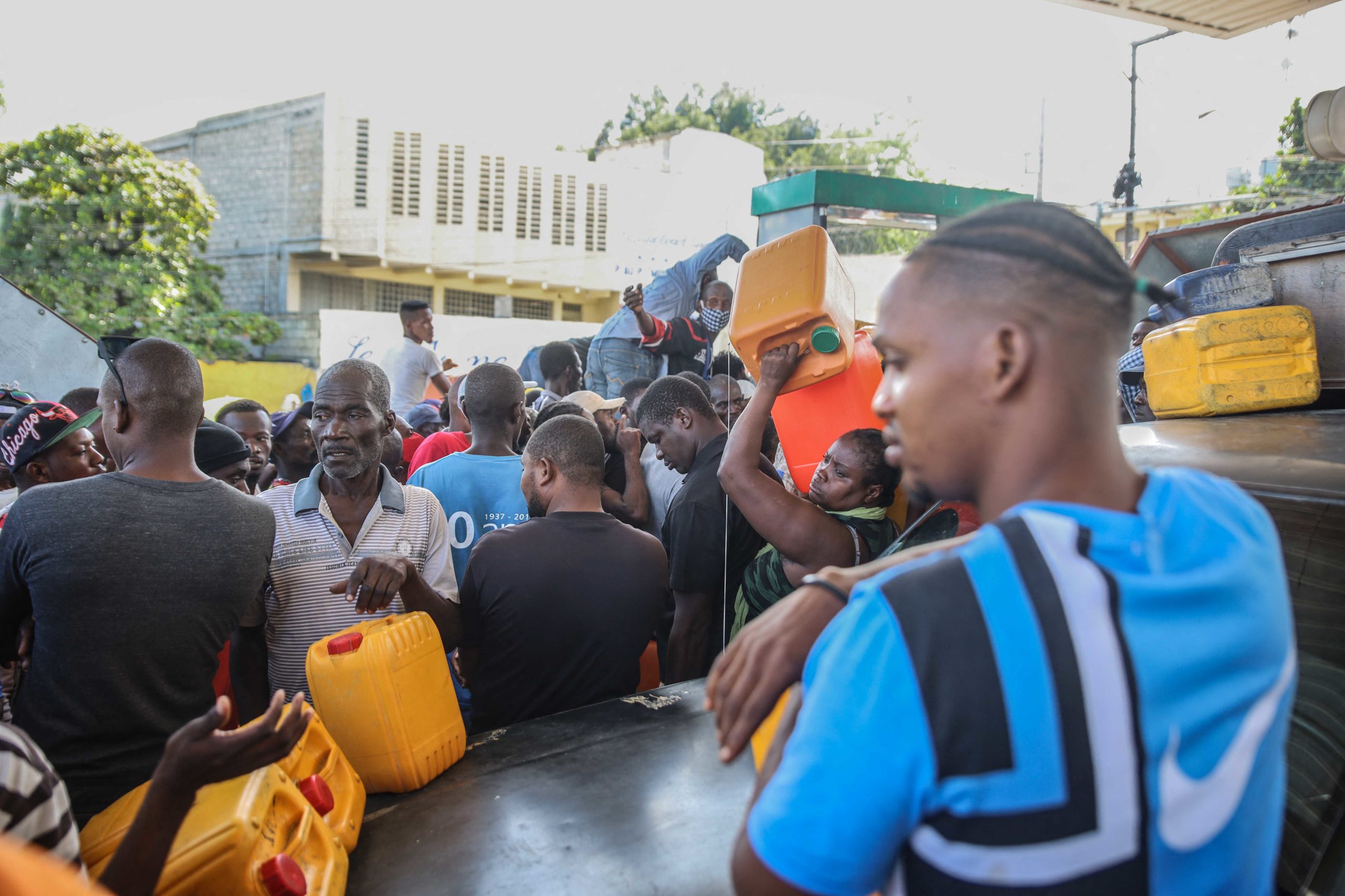 People line up with empty jerry cans at a gas station of Port-au-Prince, Haiti on November 1, 2021. (Photo by RICHARD PIERRIN/AFP via Getty Images)