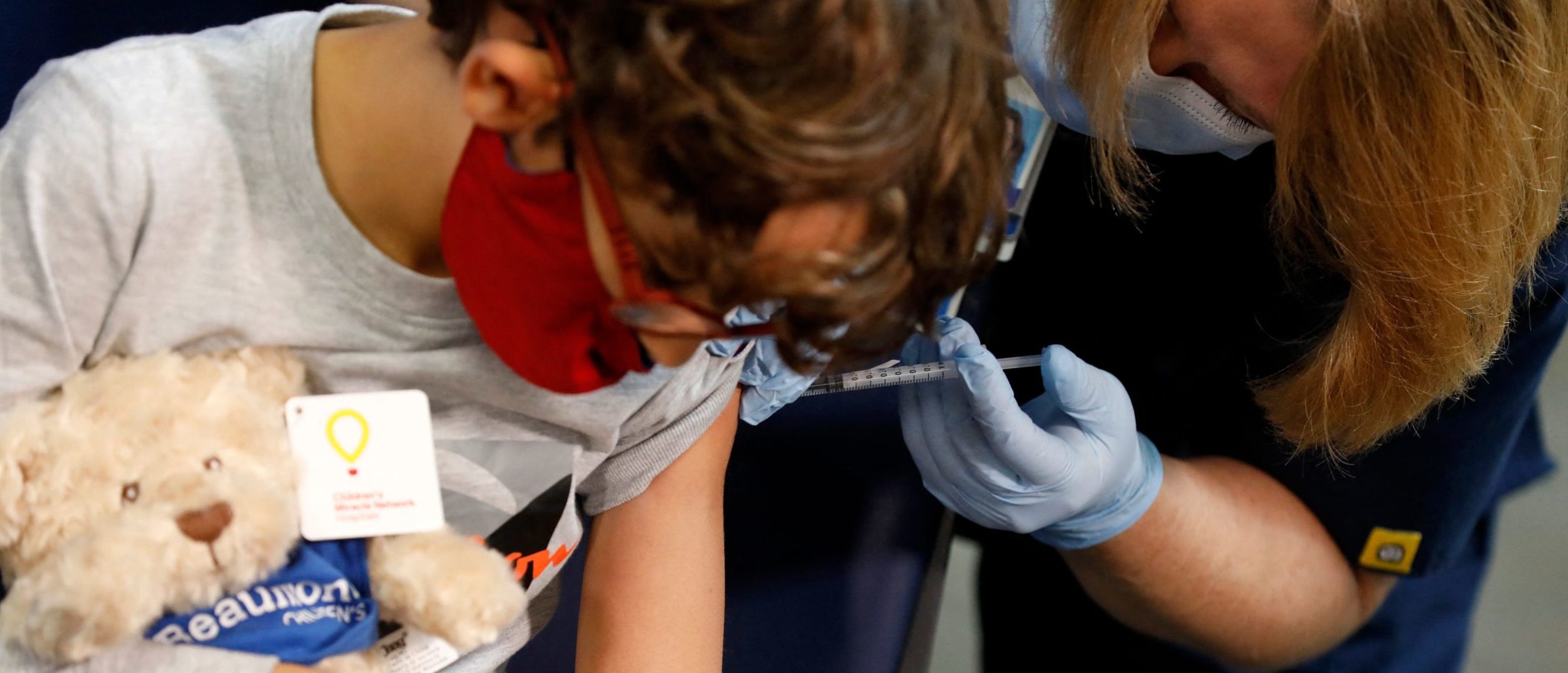 A 7 year-old child receives their first dose of the Pfizer Covid-19 vaccine at the Beaumont Health offices in Southfield, Michigan on November 5, 2021. (Photo by JEFF KOWALSKY / AFP) (Photo by JEFF KOWALSKY/AFP via Getty Images)