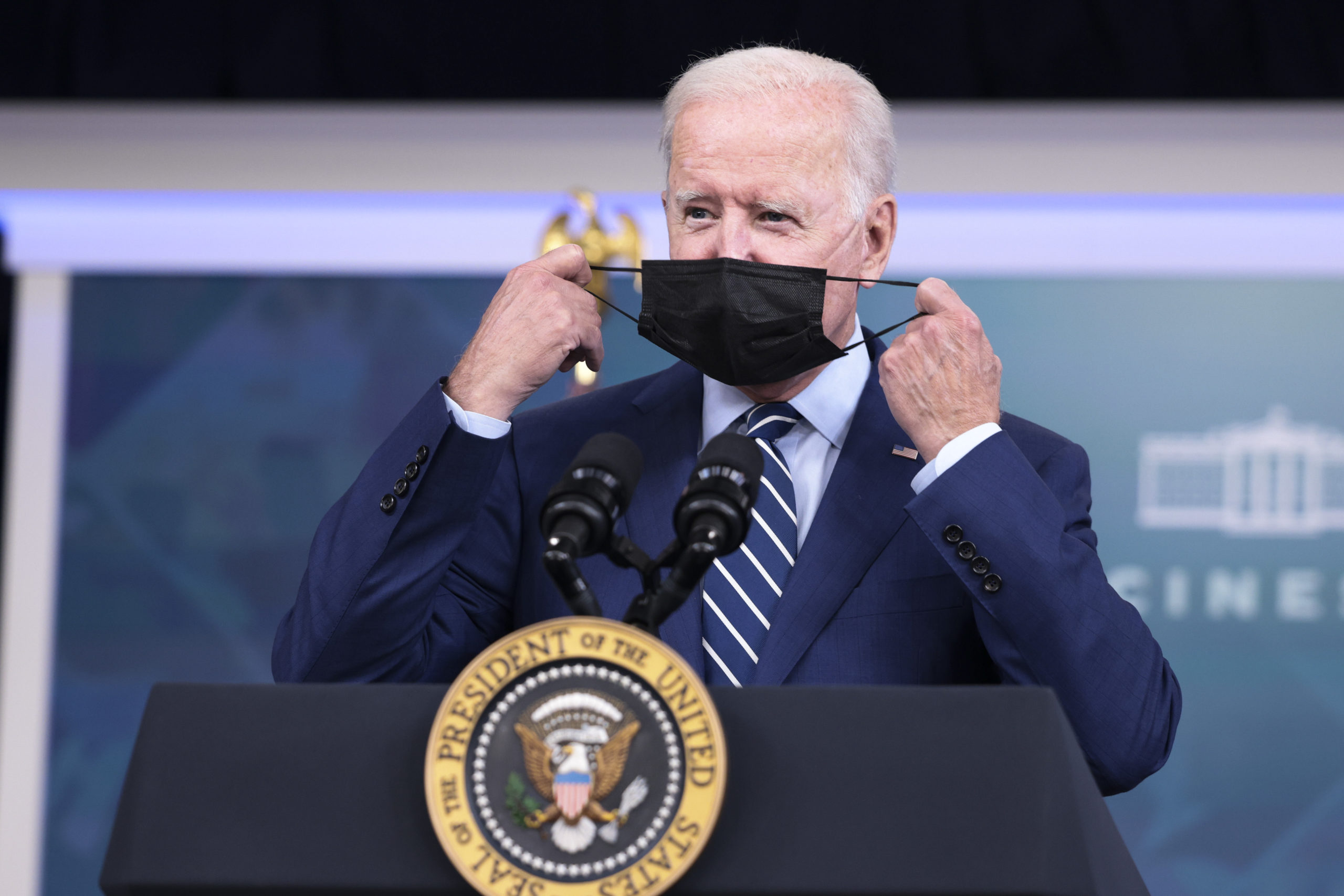 WASHINGTON, DC - SEPTEMBER 27: U.S. President Joe Biden removes his face mask before giving remarks ahead of receiving a third dose of the Pfizer/BioNTech Covid-19 vaccine in the South Court Auditorium in the White House September 27, 2021 in Washington, DC. Last week President Biden announced that Americans 65 and older and frontline workers who received the Pfizer-BioNTech COVID-19 vaccine over six months ago would be eligible for booster shots. (Photo by Anna Moneymaker/Getty Images)