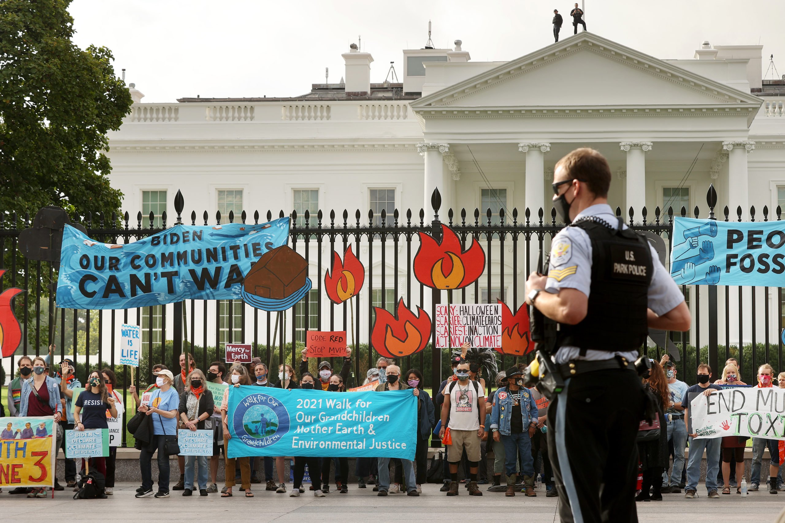 Demonstrators prepare to be arrested during a rally outside the White House as part of the 'Climate Chaos Is Happening Now' protest on Oct. 13. (Chip Somodevilla/Getty Images)