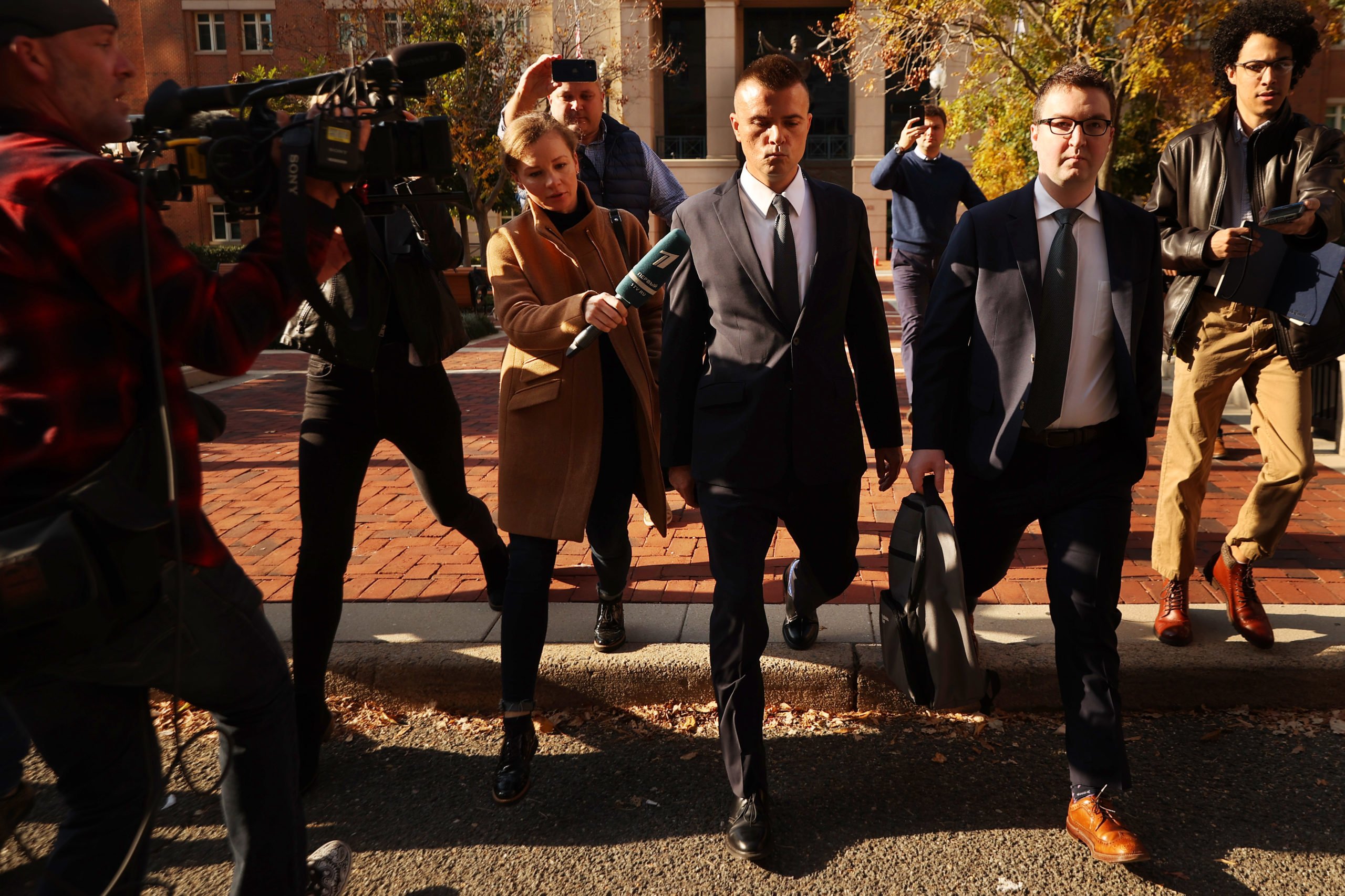 ALEXANDRIA, VA - NOVEMBER 10: Russian analyst Igor Danchenko is pursued by journalists as he departs the Albert V. Bryan U.S. Courthouse after being arraigned on November 10, 2021 in Alexandria, Virginia. Danchenko has been charged with five counts of making false statements to the FBI regarding the sources of the information he gave the British firm that created the so-called "Steele Dossier," which alleged potential ties between the 2016 Trump campaign and Russia. (Photo by Chip Somodevilla/Getty Images)