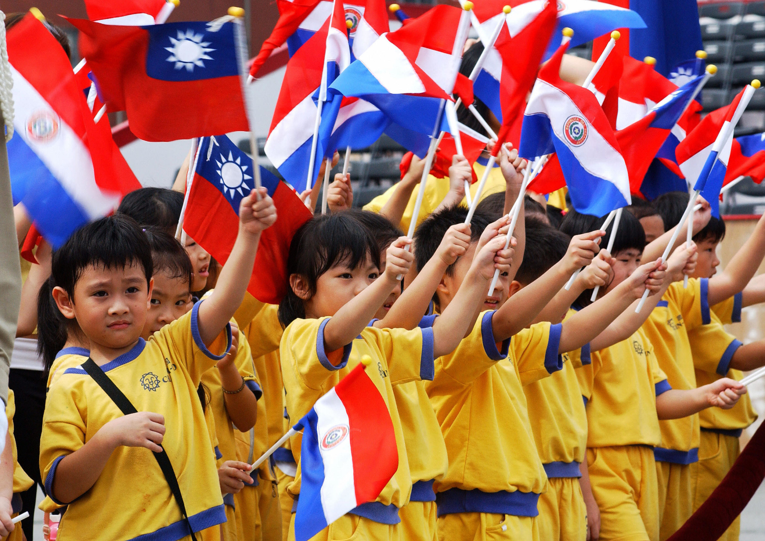 Children wave national flags of Paraguay